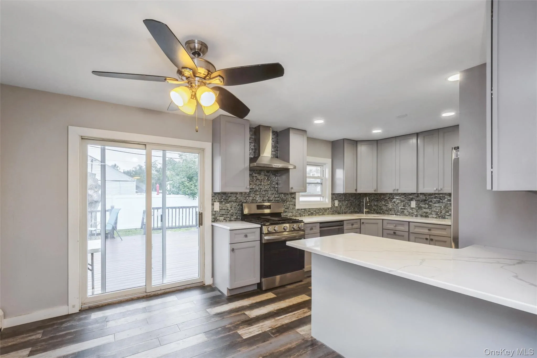 First floor renovated kitchen with quartz counter tops and stainless steel appliances. Sliders to deck in yard. First floor renovated kitchen with quartz counter tops and stainless steel appliances. Sliders to deck in yard.