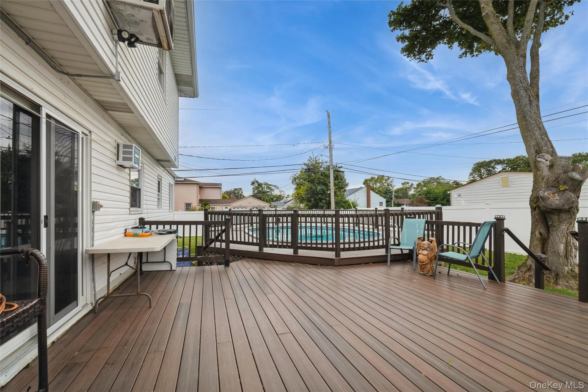Deck next to permitted partially inground pool with fence and trek decking surrounding Deck next to permitted partially inground pool with fence and trek decking surrounding