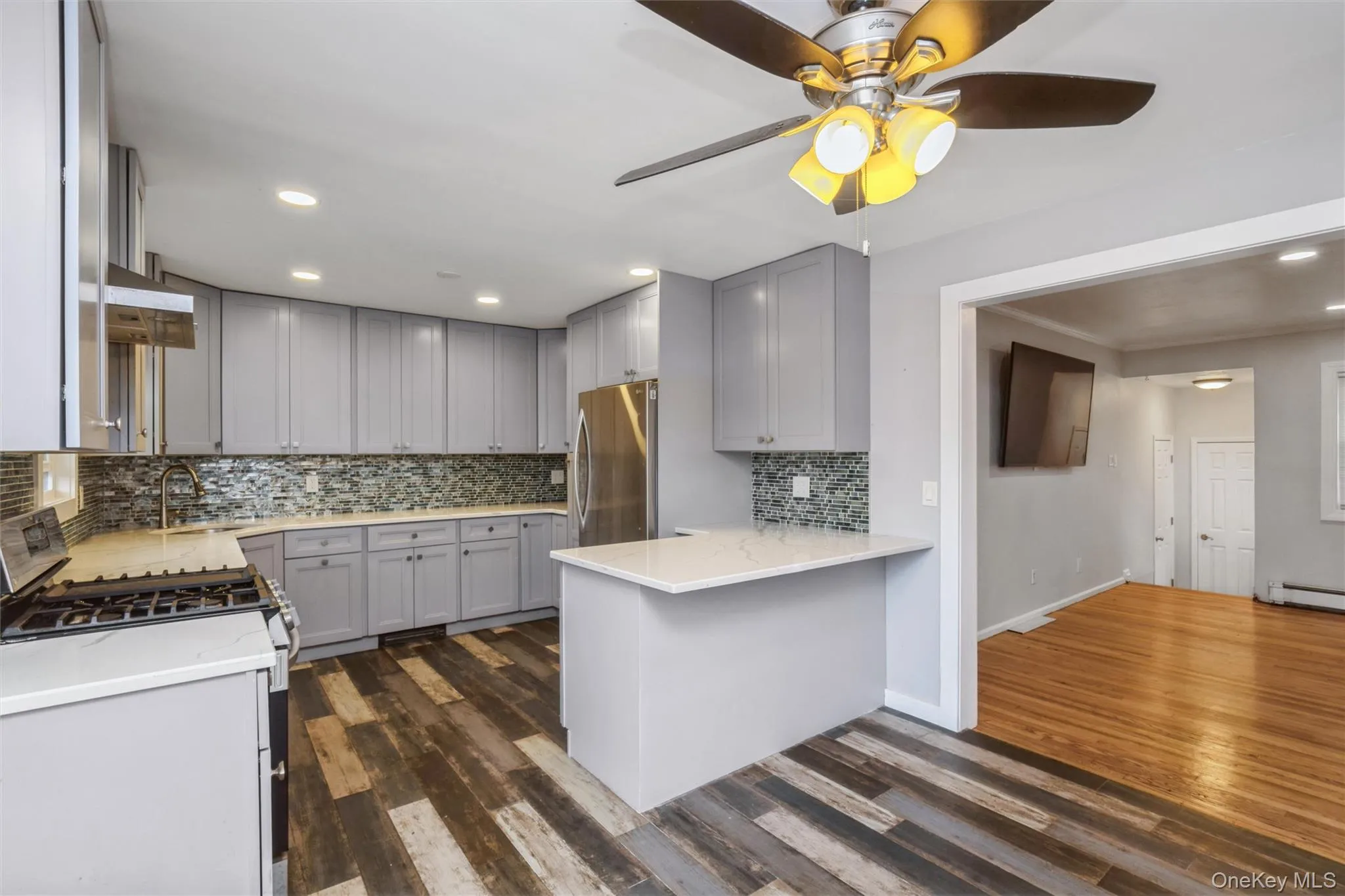 First floor renovated kitchen with quartz counter tops and stainless steel appliances. First floor renovated kitchen with quartz counter tops and stainless steel appliances.