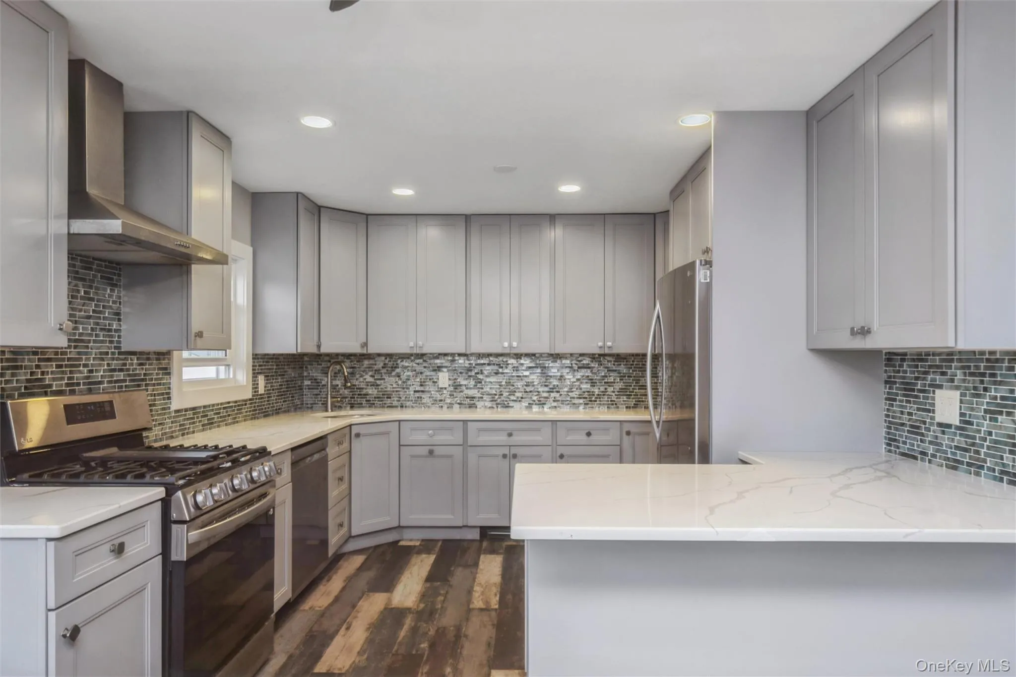 First floor renovated kitchen with quartz counter tops and stainless steel appliances. First floor renovated kitchen with quartz counter tops and stainless steel appliances.