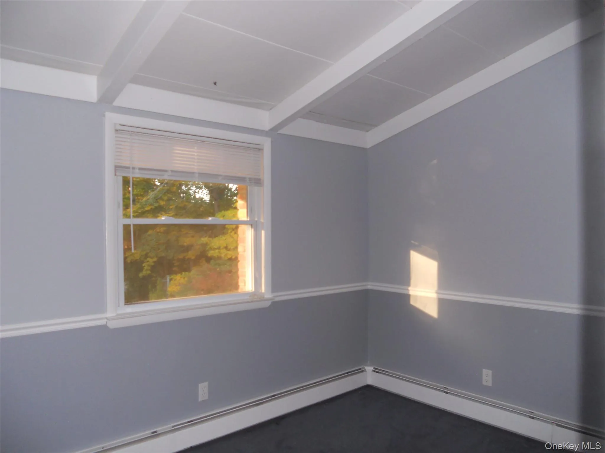 Window with white trim, two-tone wall finish, and ceiling with exposed beams Window with white trim, two-tone wall finish, and ceiling with exposed beams