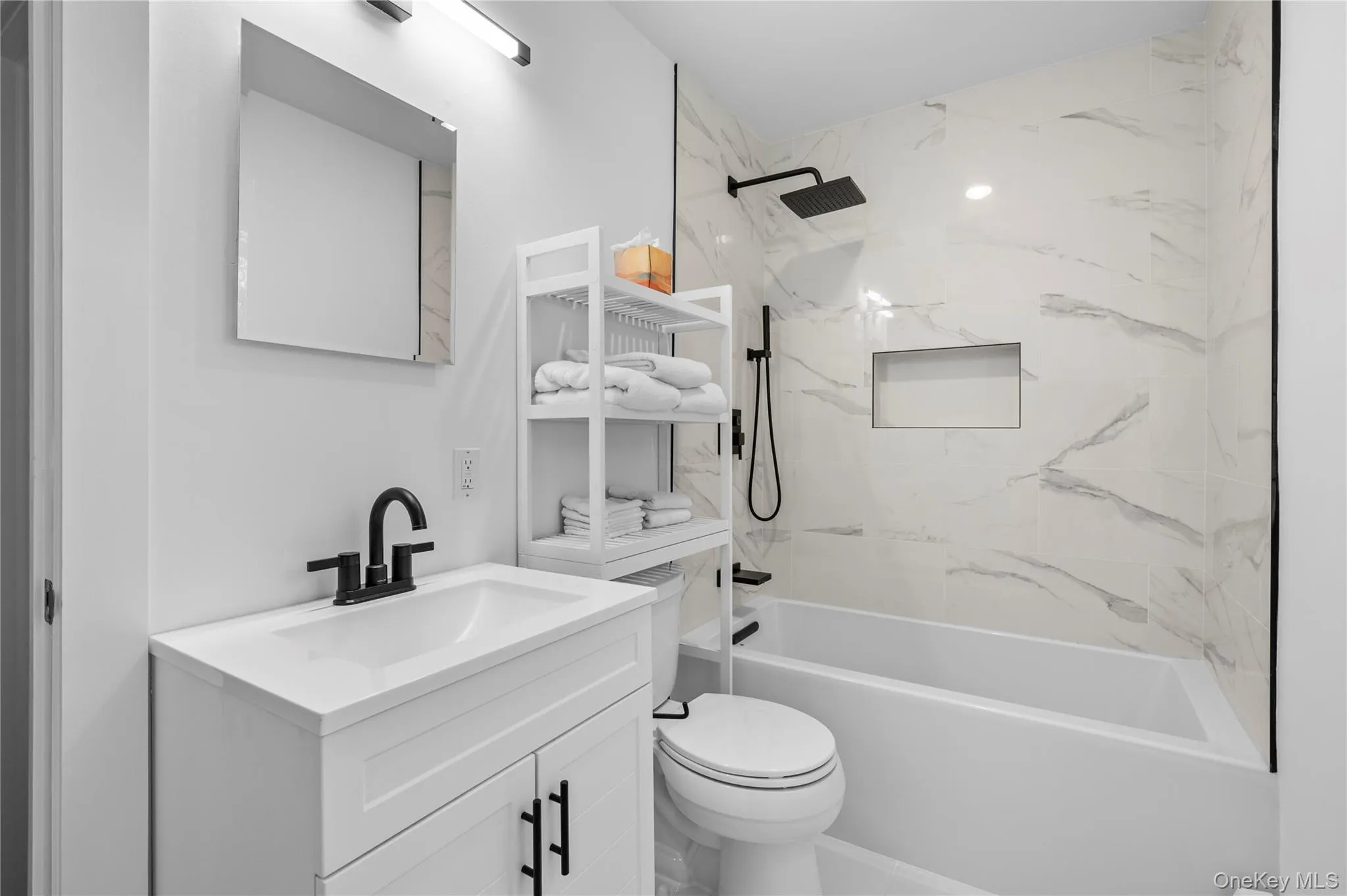 Full bathroom with a combined bath / shower with marble appearance and vanity Full bathroom with a combined bath / shower with marble appearance and vanity