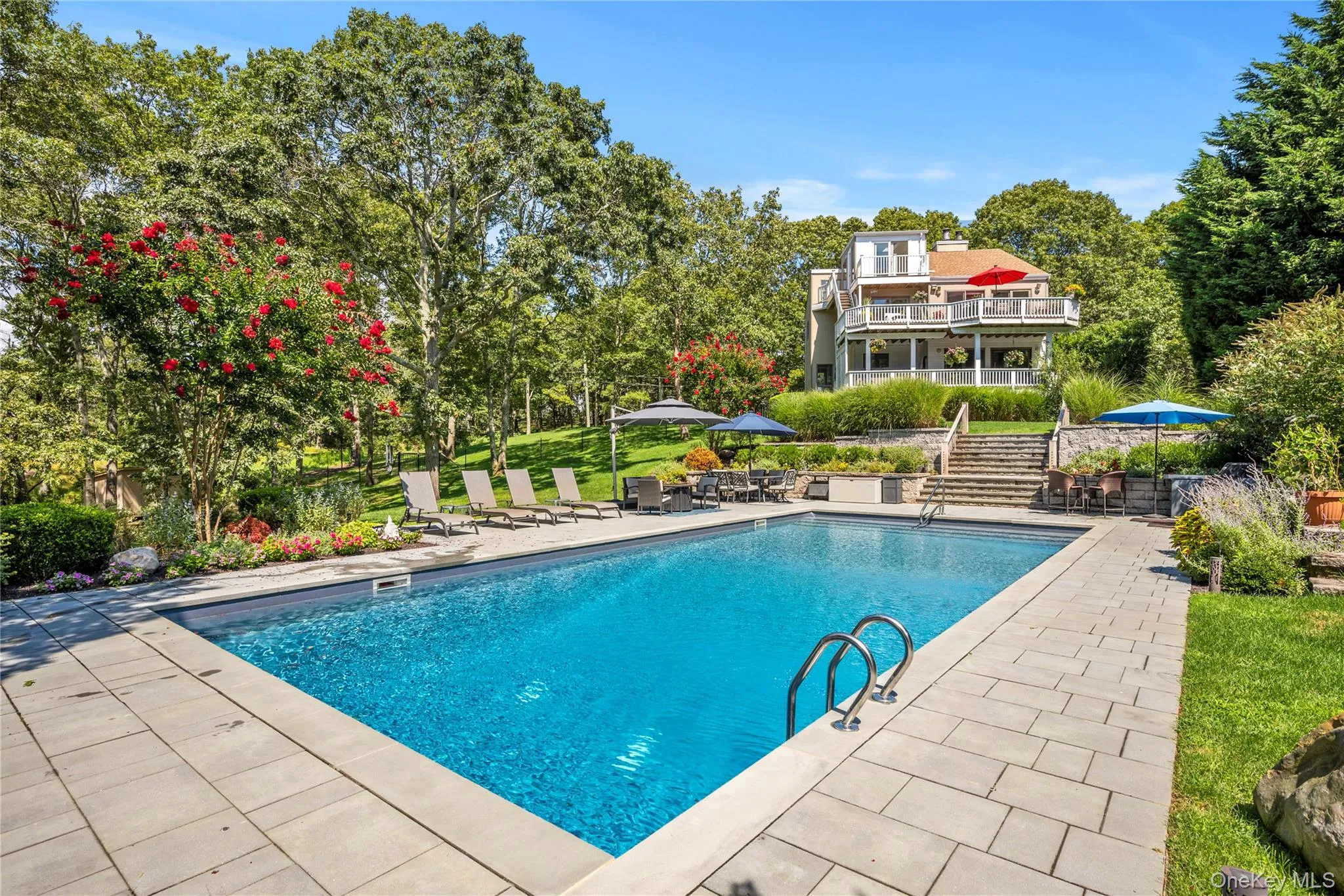 Outdoor pool featuring a patio area and stairway Outdoor pool featuring a patio area and stairway