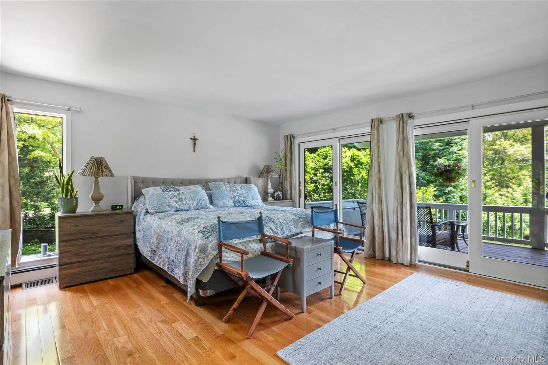 Bedroom with light wood-type flooring and access to exterior Bedroom with light wood-type flooring and access to exterior