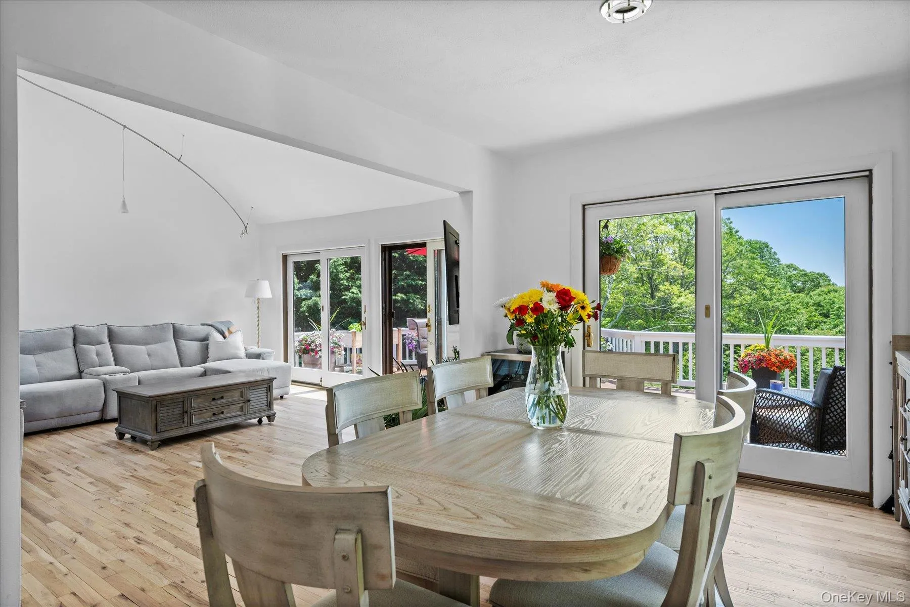 Dining area with light wood finished floors and vaulted ceiling Dining area with light wood finished floors and vaulted ceiling