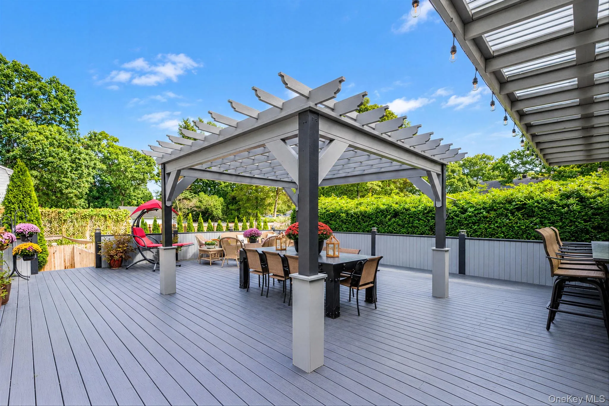 Spacious Deck with Multiple Seating Areas, Pergola, Outdoor Bar with Beverage Fridges, Storage, Outdoor TV Spacious Deck with Multiple Seating Areas, Pergola, Outdoor Bar with Beverage Fridges, Storage, Outdoor TV