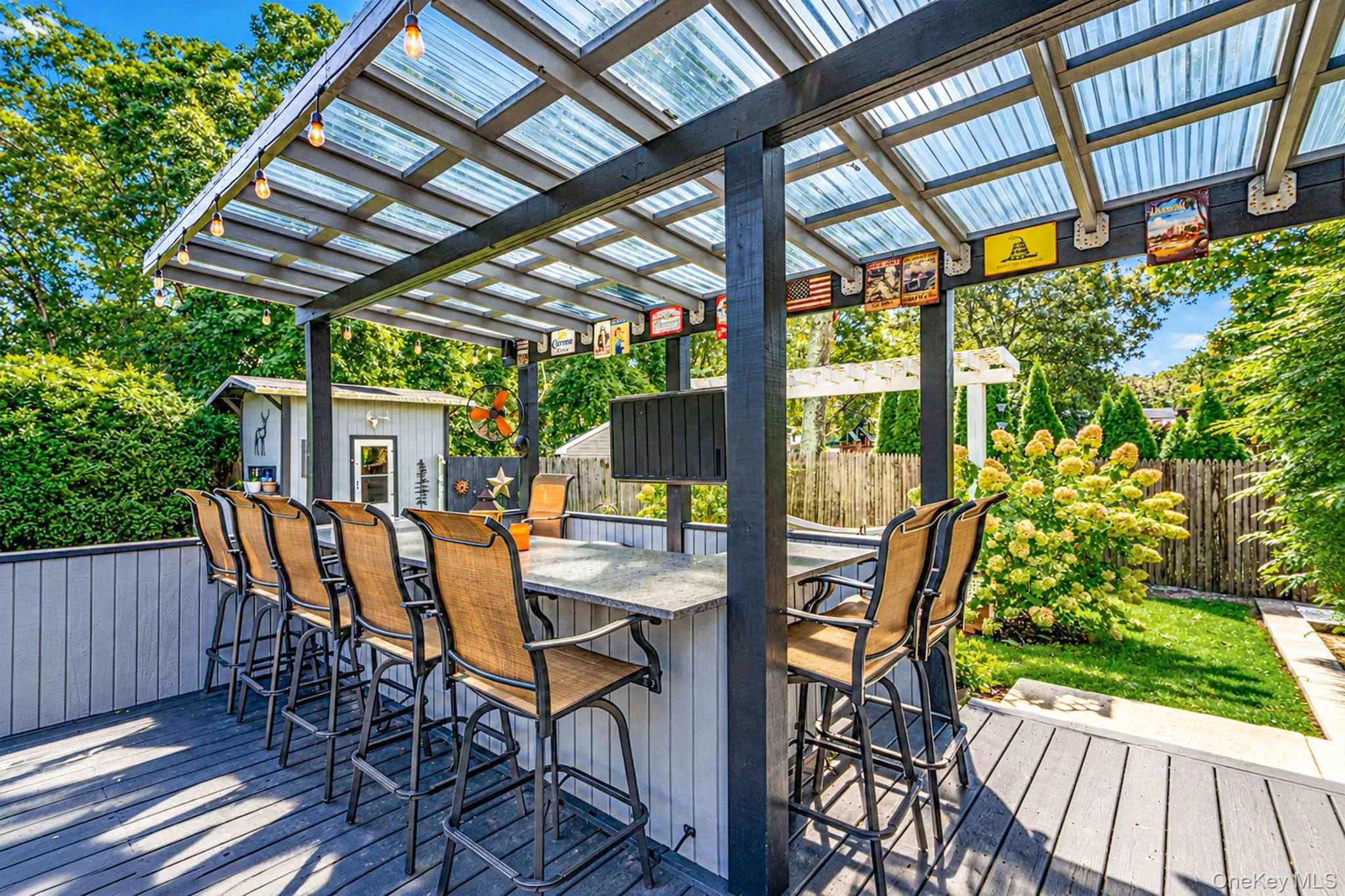 Spacious Deck with Multiple Seating Areas, Pergola, Outdoor Bar with Beverage Fridges, Storage, Outdoor TV Spacious Deck with Multiple Seating Areas, Pergola, Outdoor Bar with Beverage Fridges, Storage, Outdoor TV