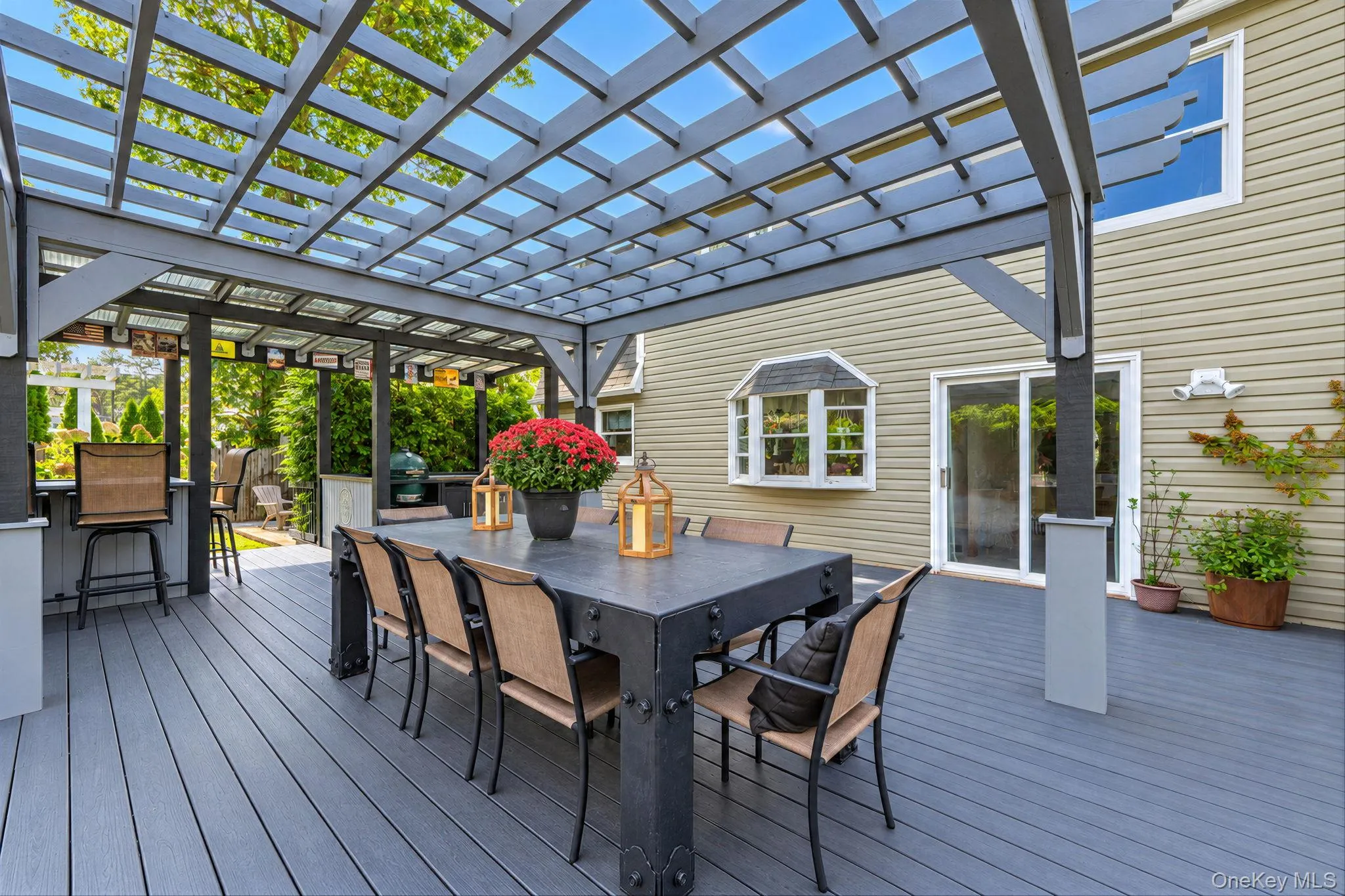 Spacious Deck with Multiple Seating Areas, Pergola, Outdoor Bar with Beverage Fridges, Storage, Outdoor TV Spacious Deck with Multiple Seating Areas, Pergola, Outdoor Bar with Beverage Fridges, Storage, Outdoor TV