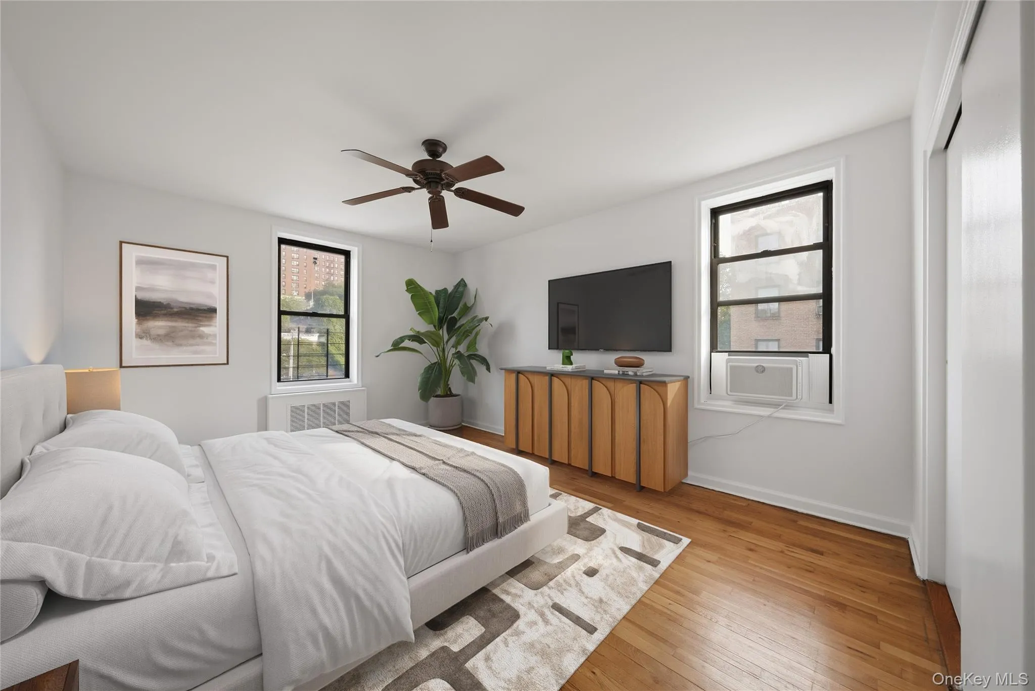 Virtually staged windowed primary bedroom with double exposures Virtually staged windowed primary bedroom with double exposures
