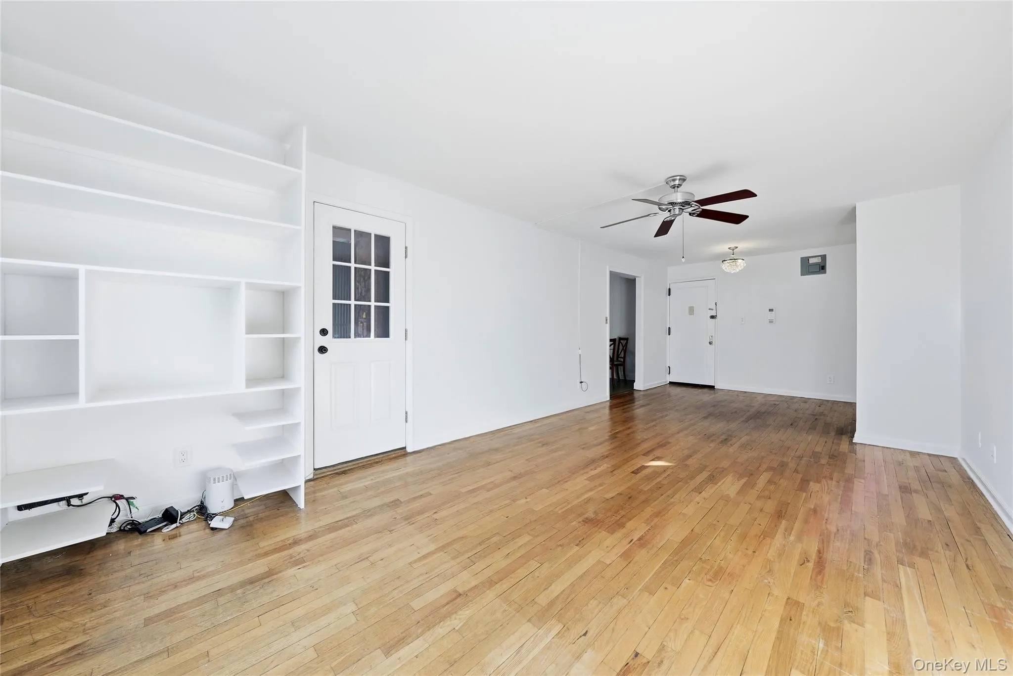 Living dining area with built-ins and entry to private balcony and kitchen Living dining area with built-ins and entry to private balcony and kitchen