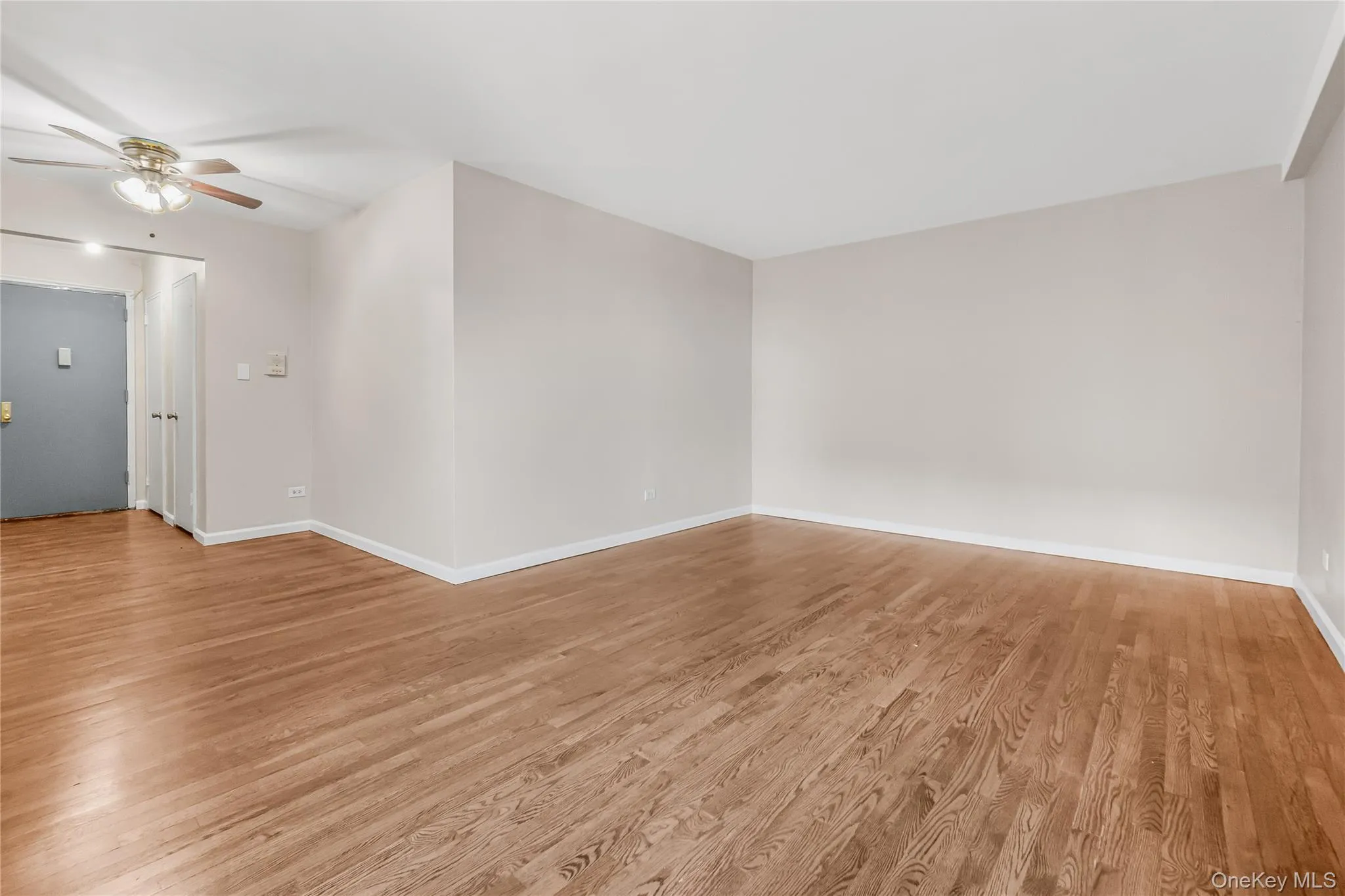 Empty room with light wood-type flooring and ceiling fan Empty room with light wood-type flooring and ceiling fan