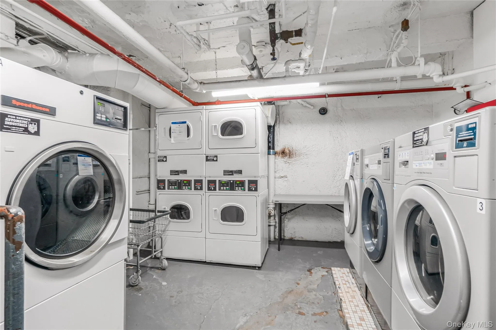 Shared laundry with washer and clothes dryer and stacked washing machine and dryer Shared laundry with washer and clothes dryer and stacked washing machine and dryer