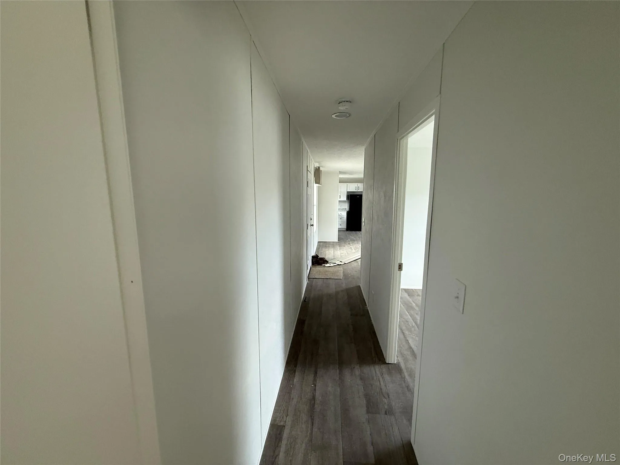 Corridor featuring dark wood-style flooring Corridor featuring dark wood-style flooring