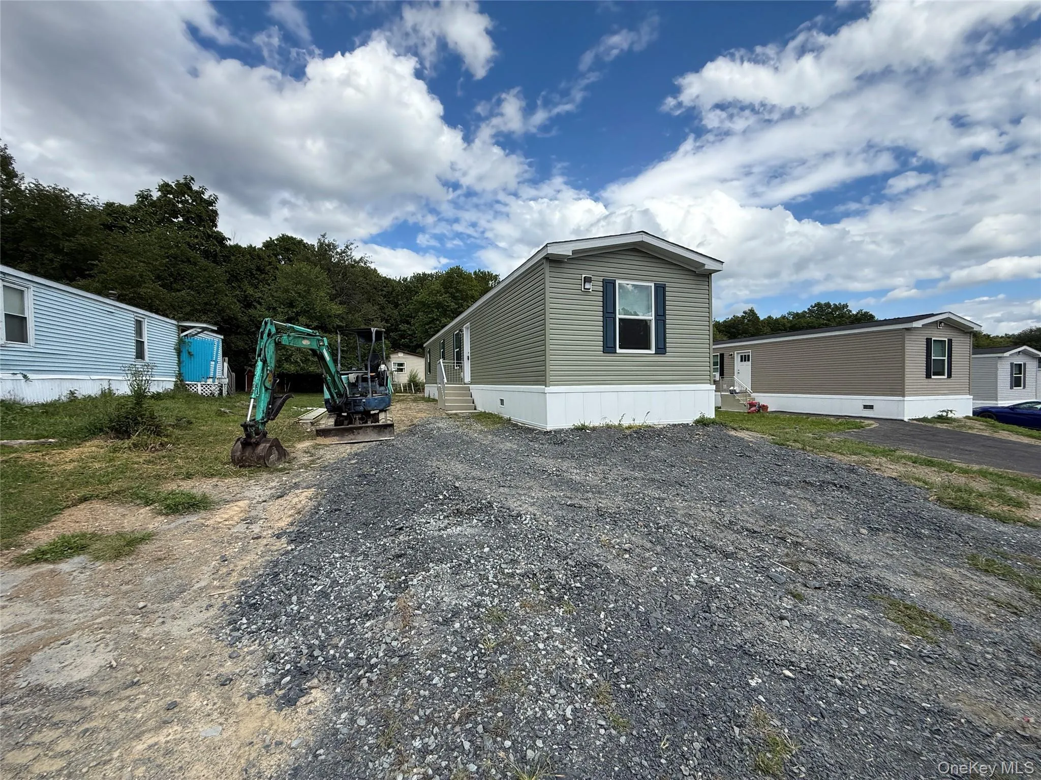 View of home's exterior featuring gravel driveway View of home's exterior featuring gravel driveway