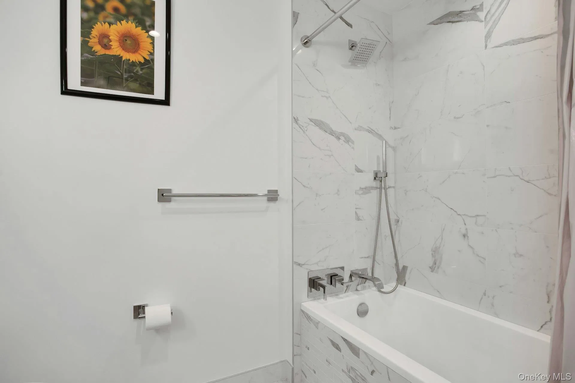 Full bath featuring a combined bath / shower with marble appearance Full bath featuring a combined bath / shower with marble appearance