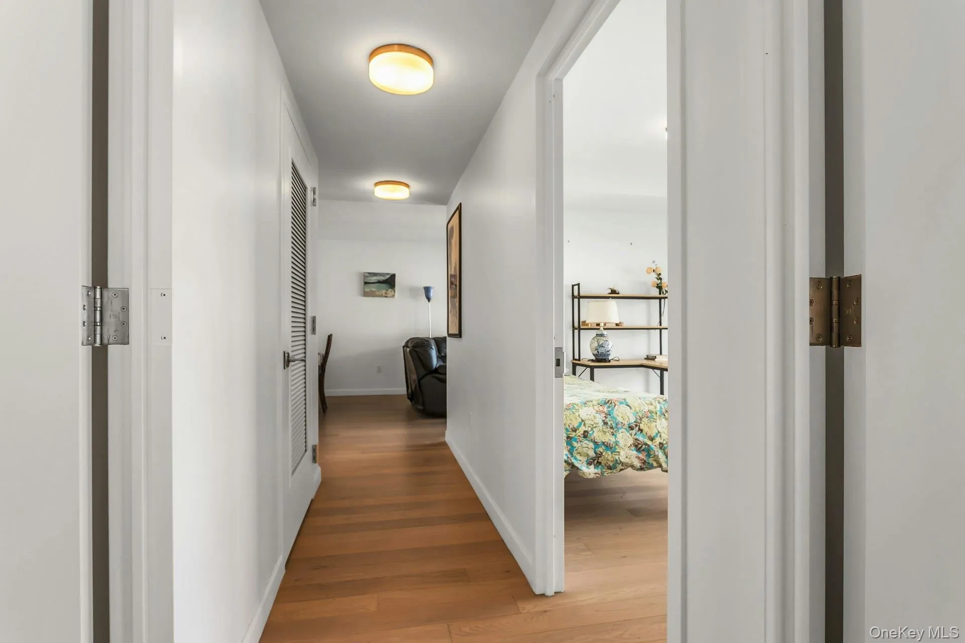 Hall with wood finished floors and baseboards Hall with wood finished floors and baseboards
