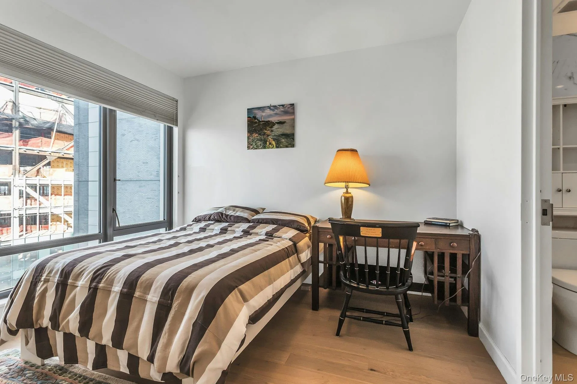 Bedroom featuring light wood-type flooring and baseboards Bedroom featuring light wood-type flooring and baseboards