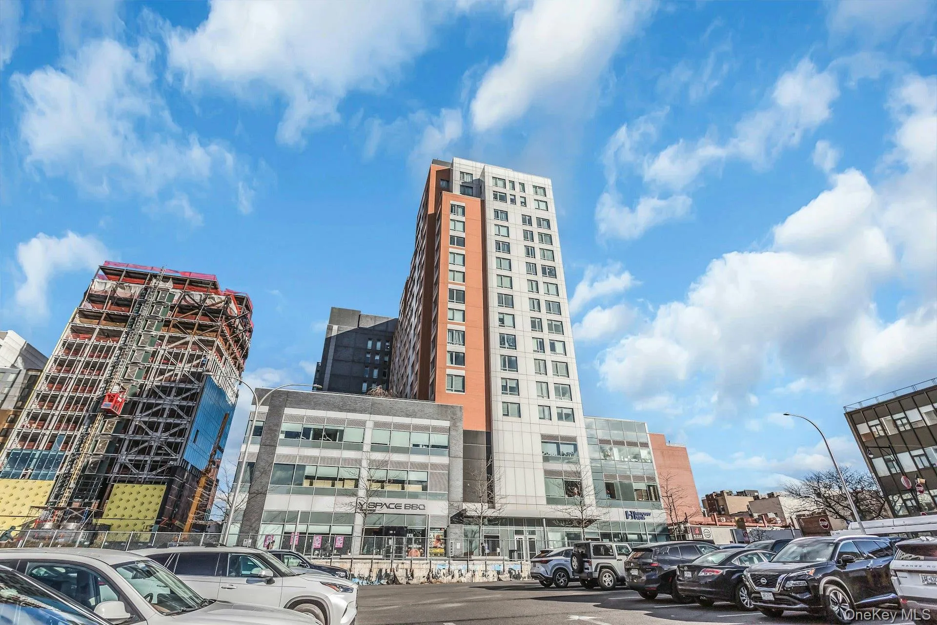 View of apartment building / complex with a city view and uncovered parking View of apartment building / complex with a city view and uncovered parking