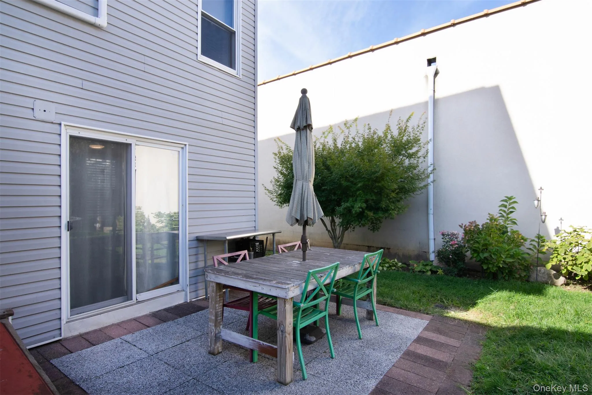 Patio area with sliding glass doors to house Patio area with sliding glass doors to house