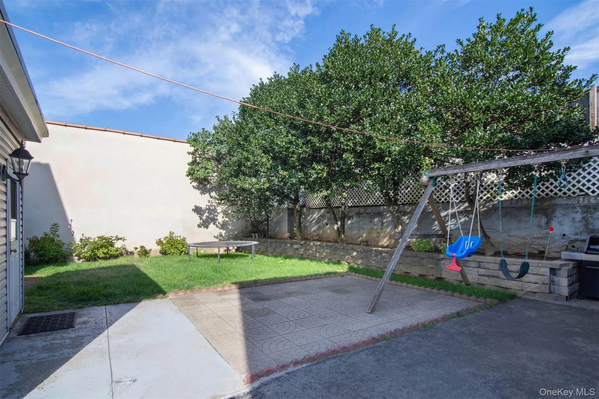 Level Private backyard with patio and play area Level Private backyard with patio and play area