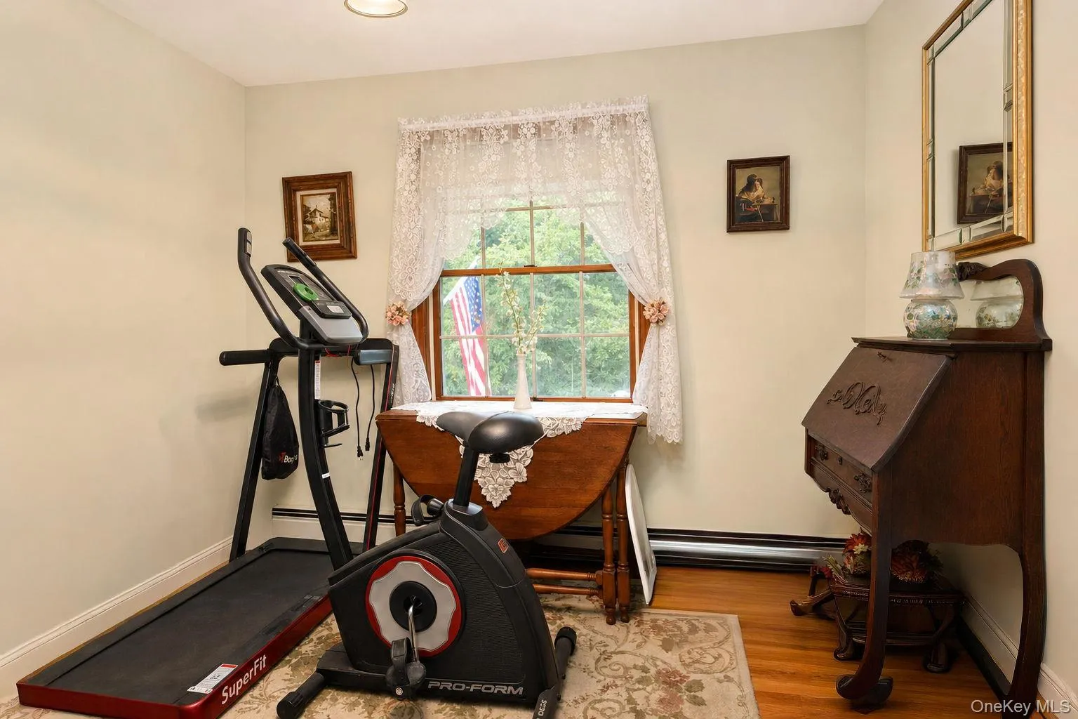 Hardwood flooring, painted walls, window with trim, and recessed ceiling light Hardwood flooring, painted walls, window with trim, and recessed ceiling light