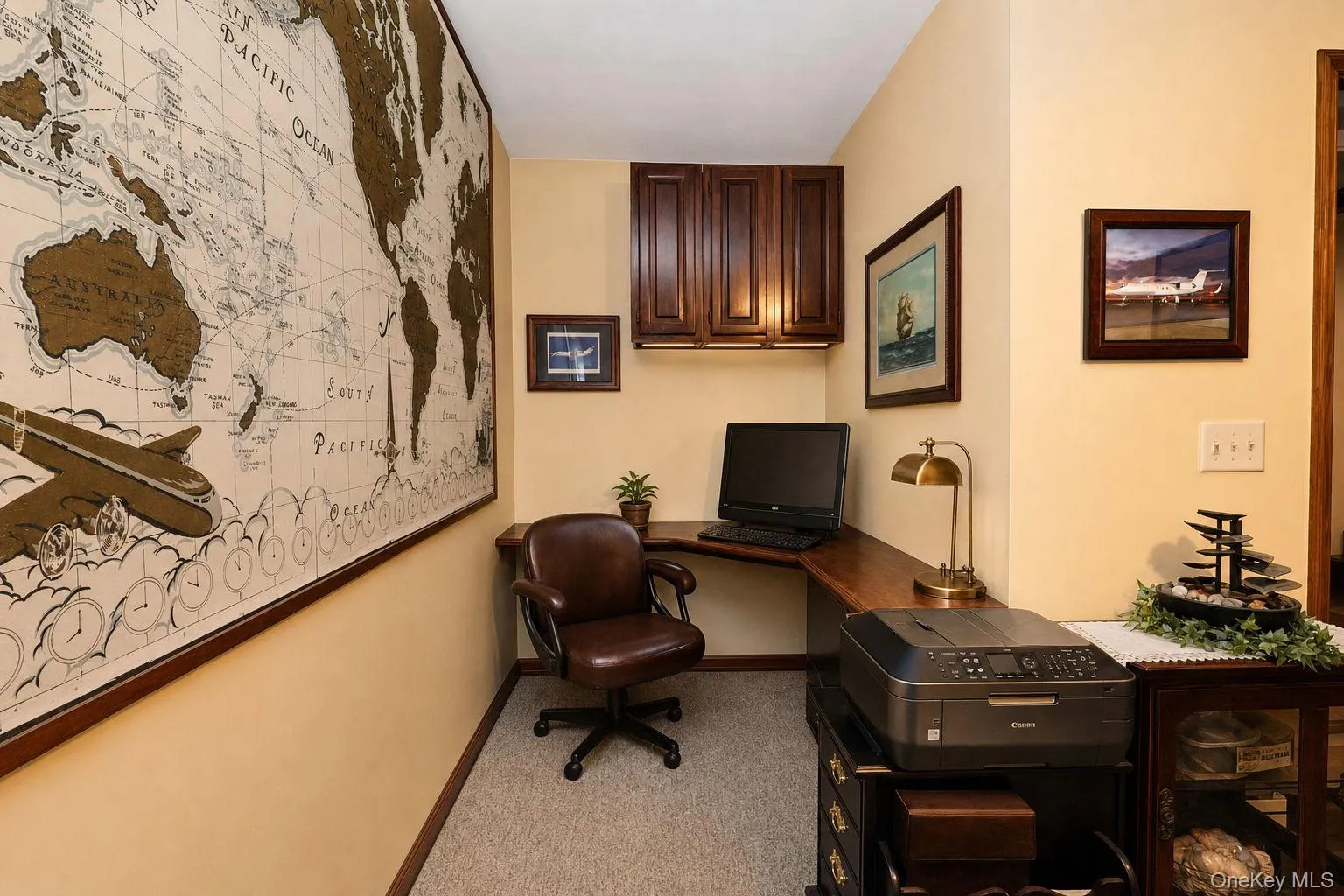L shaped office with corner configuration, recessed lighting, upper wood-finish cabinetry and door to rear deck L shaped office with corner configuration, recessed lighting, upper wood-finish cabinetry and door to rear deck