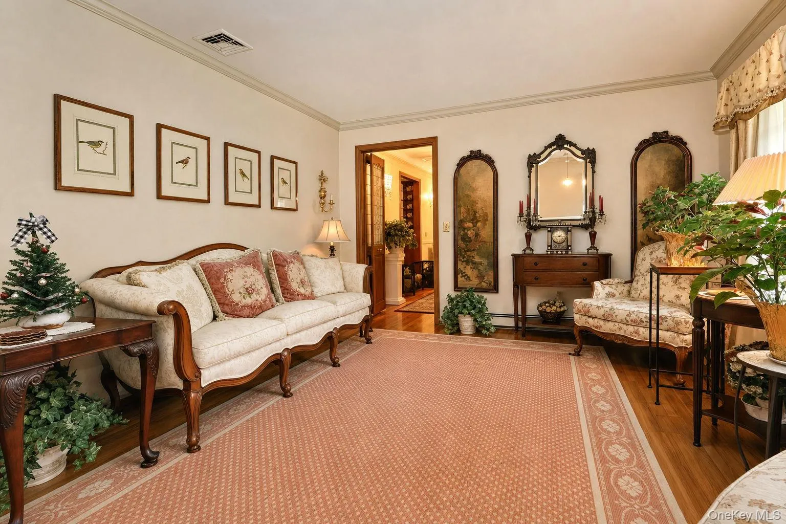 Hardwood flooring, crown molding, and a decorative area rug define this inviting space Hardwood flooring, crown molding, and a decorative area rug define this inviting space