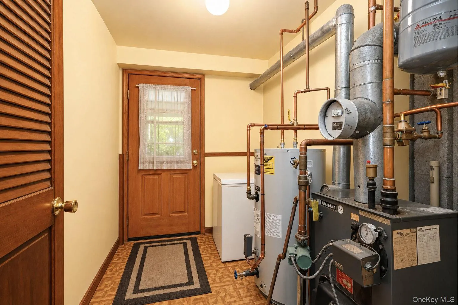 Utility room with access to the rear covered patio and rear yard Utility room with access to the rear covered patio and rear yard