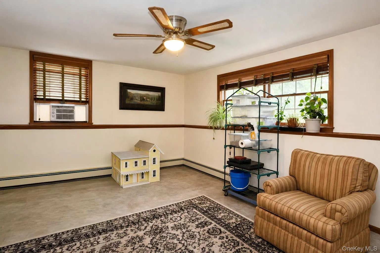 Wood-finish window trim, ceiling fan, and painted walls with accent trim Wood-finish window trim, ceiling fan, and painted walls with accent trim