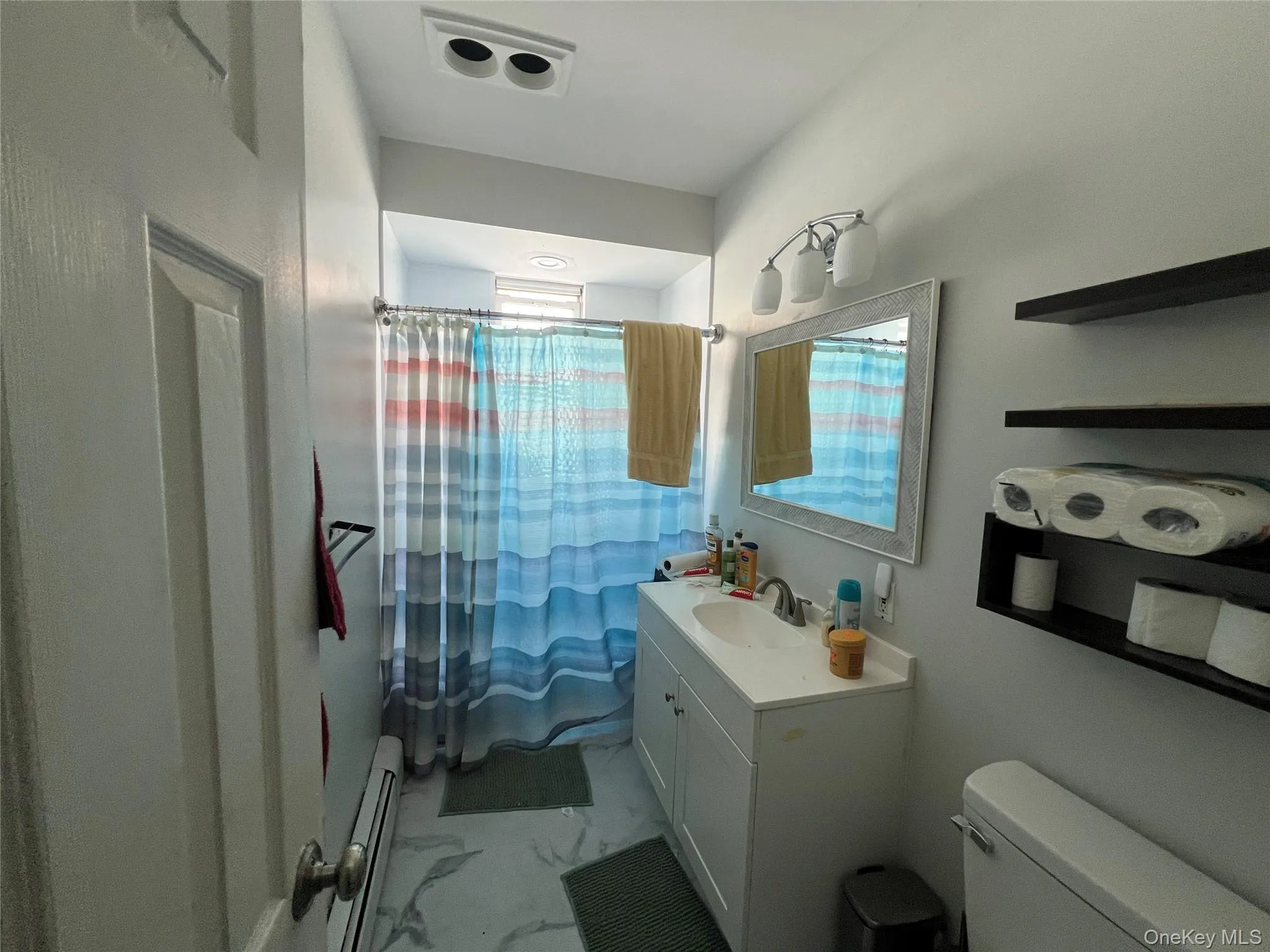 White vanity with an integrated sink and chrome faucet-Full Bathroon on second floor White vanity with an integrated sink and chrome faucet-Full Bathroon on second floor