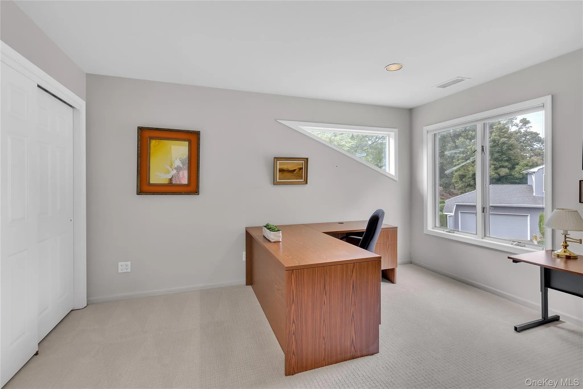 Spacious room with light gray walls, double door closet and recessed lighting. Spacious room with light gray walls, double door closet and recessed lighting.