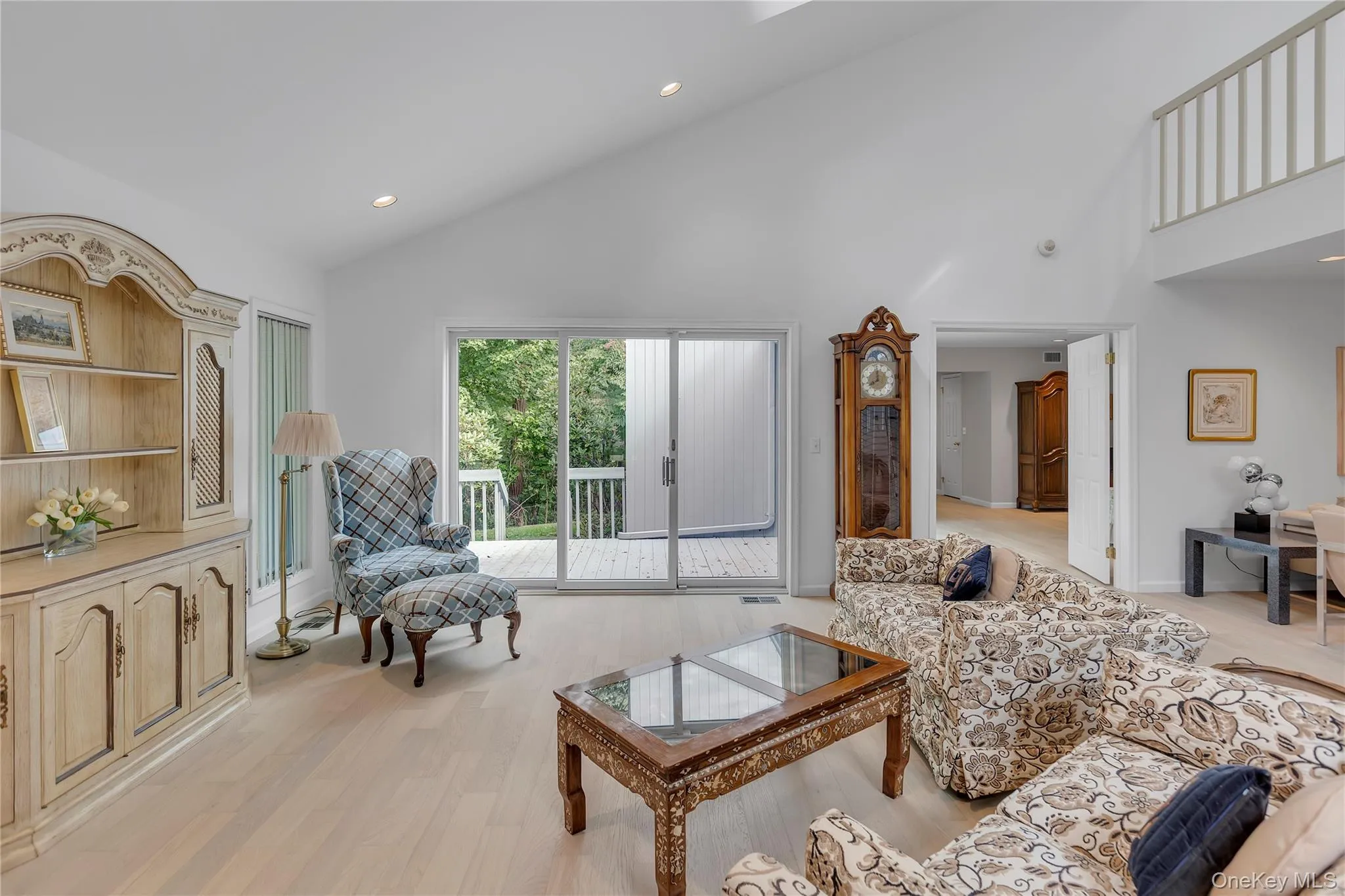 Spacious living area featuring a vaulted ceiling and recessed lighting. Spacious living area featuring a vaulted ceiling and recessed lighting.