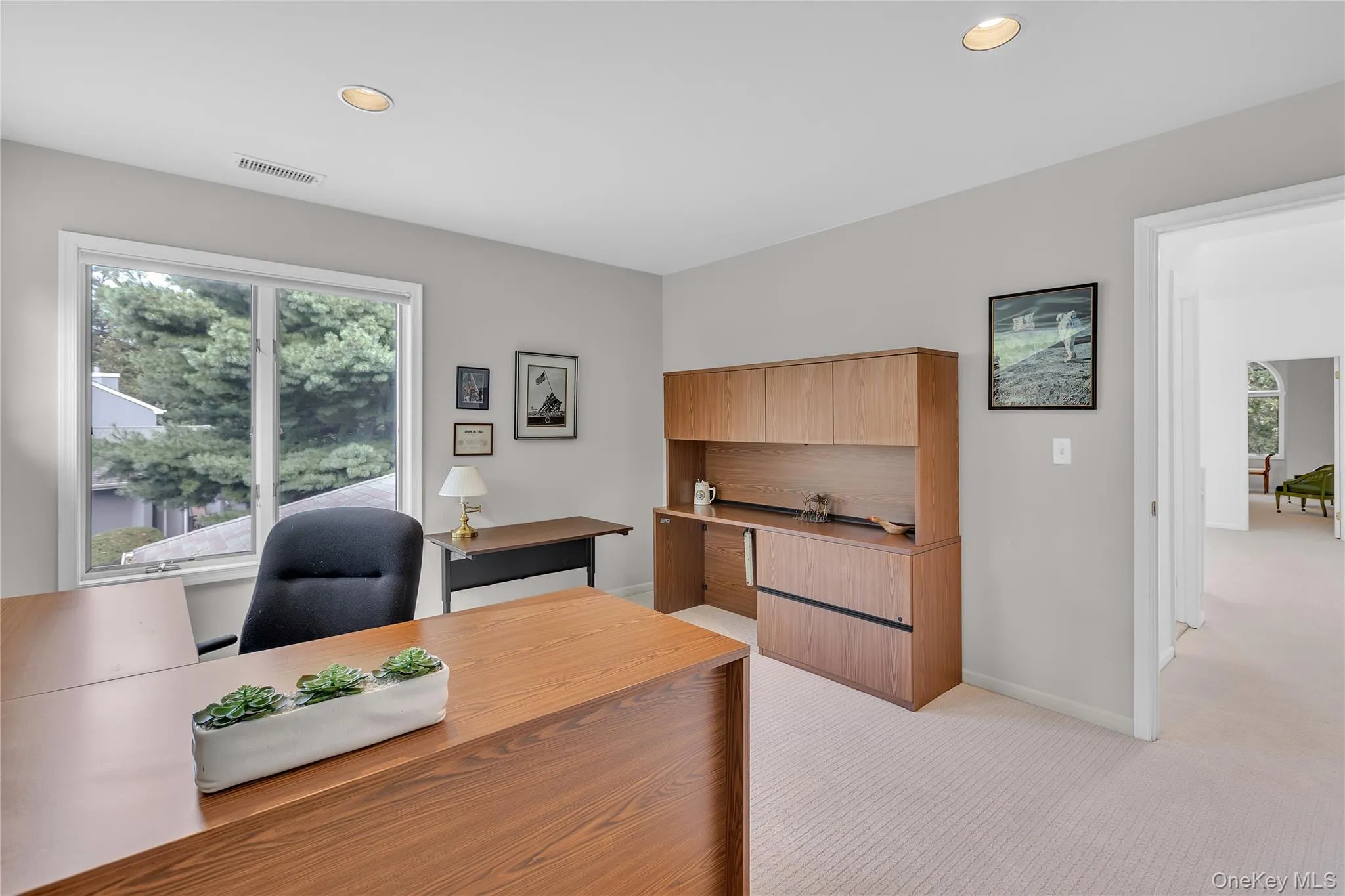 Recessed ceiling lighting, wood-finish built-in cabinetry, dual pane window, and light-toned wall paint Recessed ceiling lighting, wood-finish built-in cabinetry, dual pane window, and light-toned wall paint
