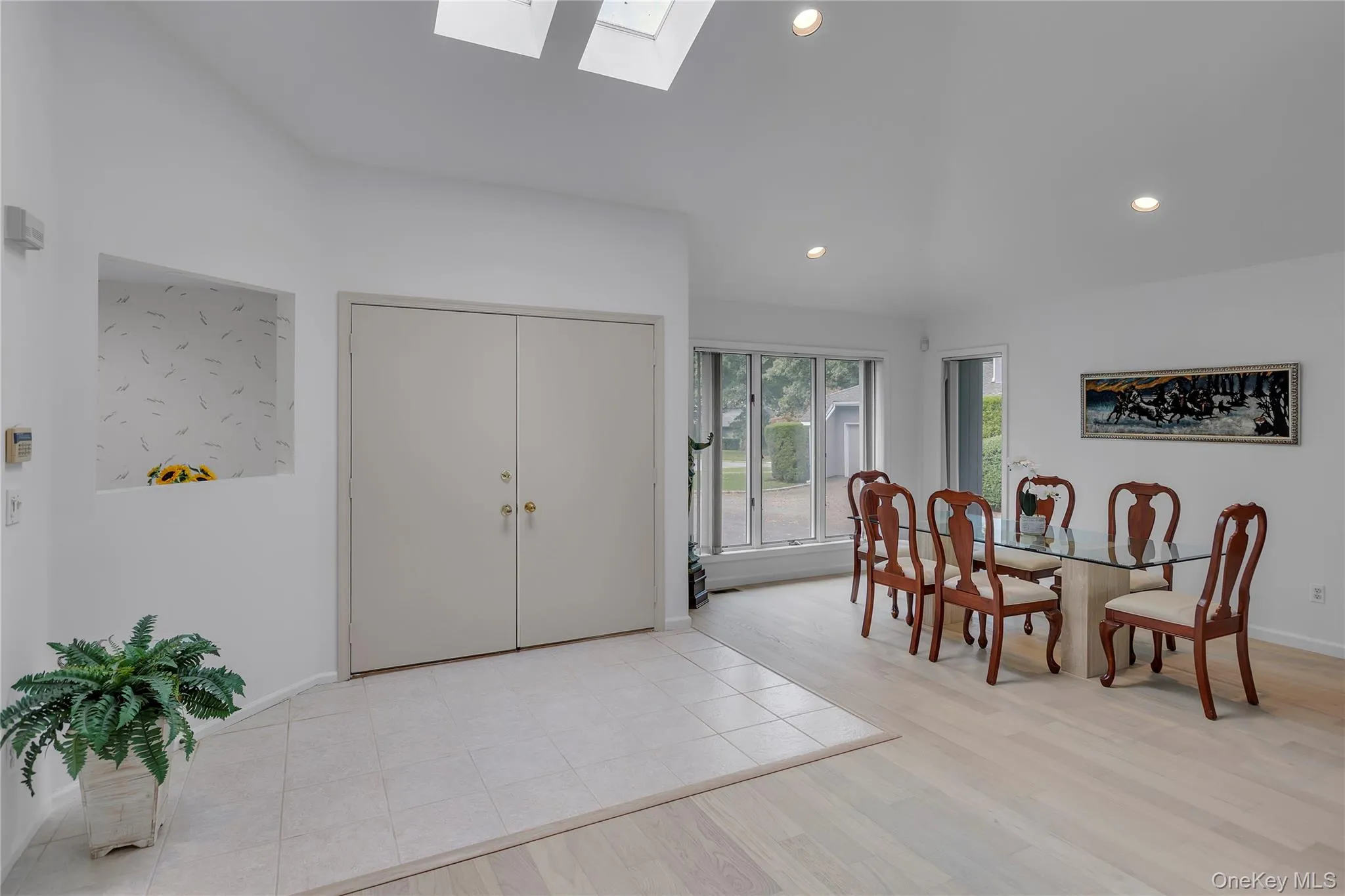 Two - story foyer featuring a vaulted ceiling with two skylights. Two - story foyer featuring a vaulted ceiling with two skylights.