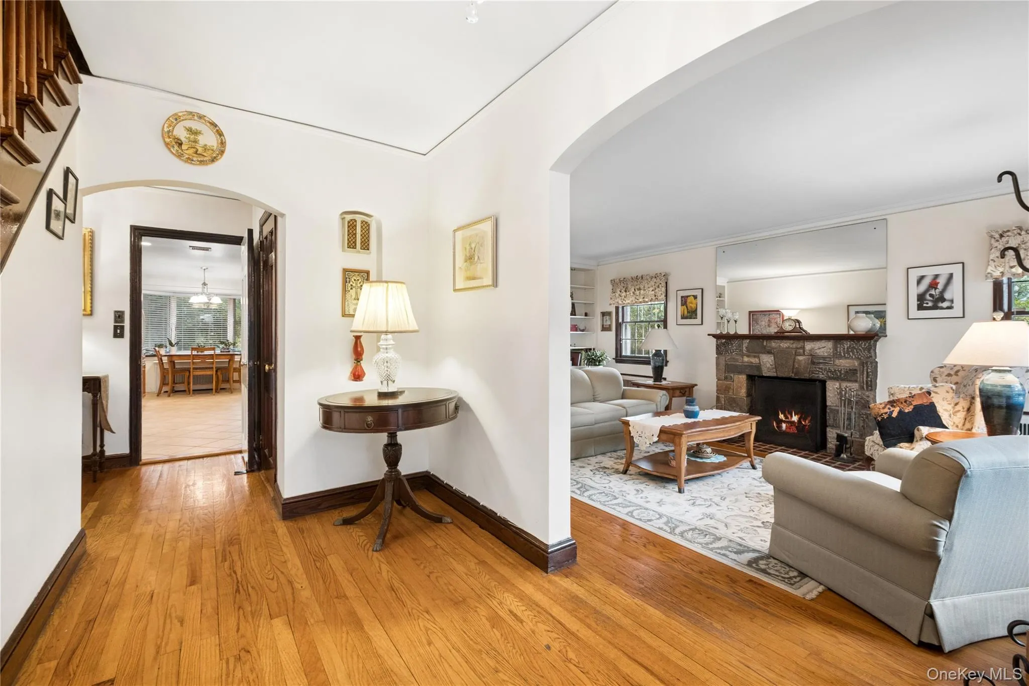 with view of living room and stone faced wood burning fireplace with view of living room and stone faced wood burning fireplace
