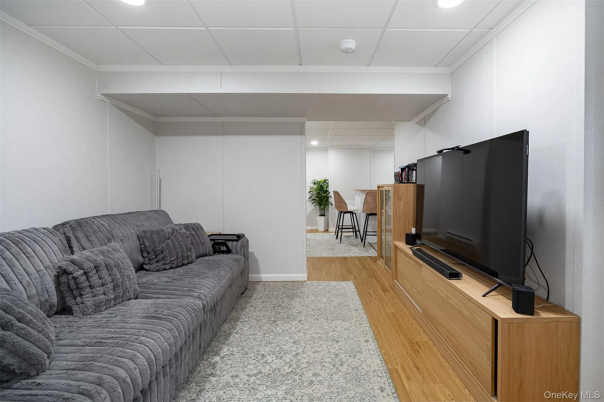 Recessed lighting illuminates the space, featuring vinyl plank flooring and a dropped ceiling Recessed lighting illuminates the space, featuring vinyl plank flooring and a dropped ceiling