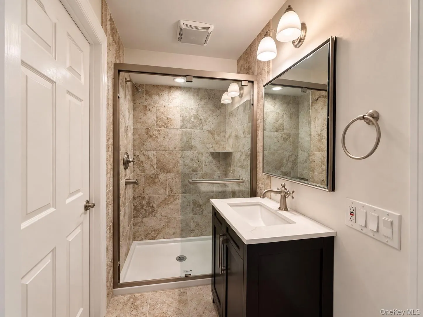 Glass-enclosed shower with tiled walls and a built-in niche Glass-enclosed shower with tiled walls and a built-in niche