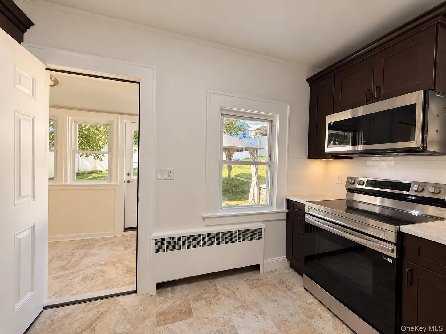 Rich wood-finish cabinetry, new stainless steel appliances, and wood-finish flooring Rich wood-finish cabinetry, new stainless steel appliances, and wood-finish flooring