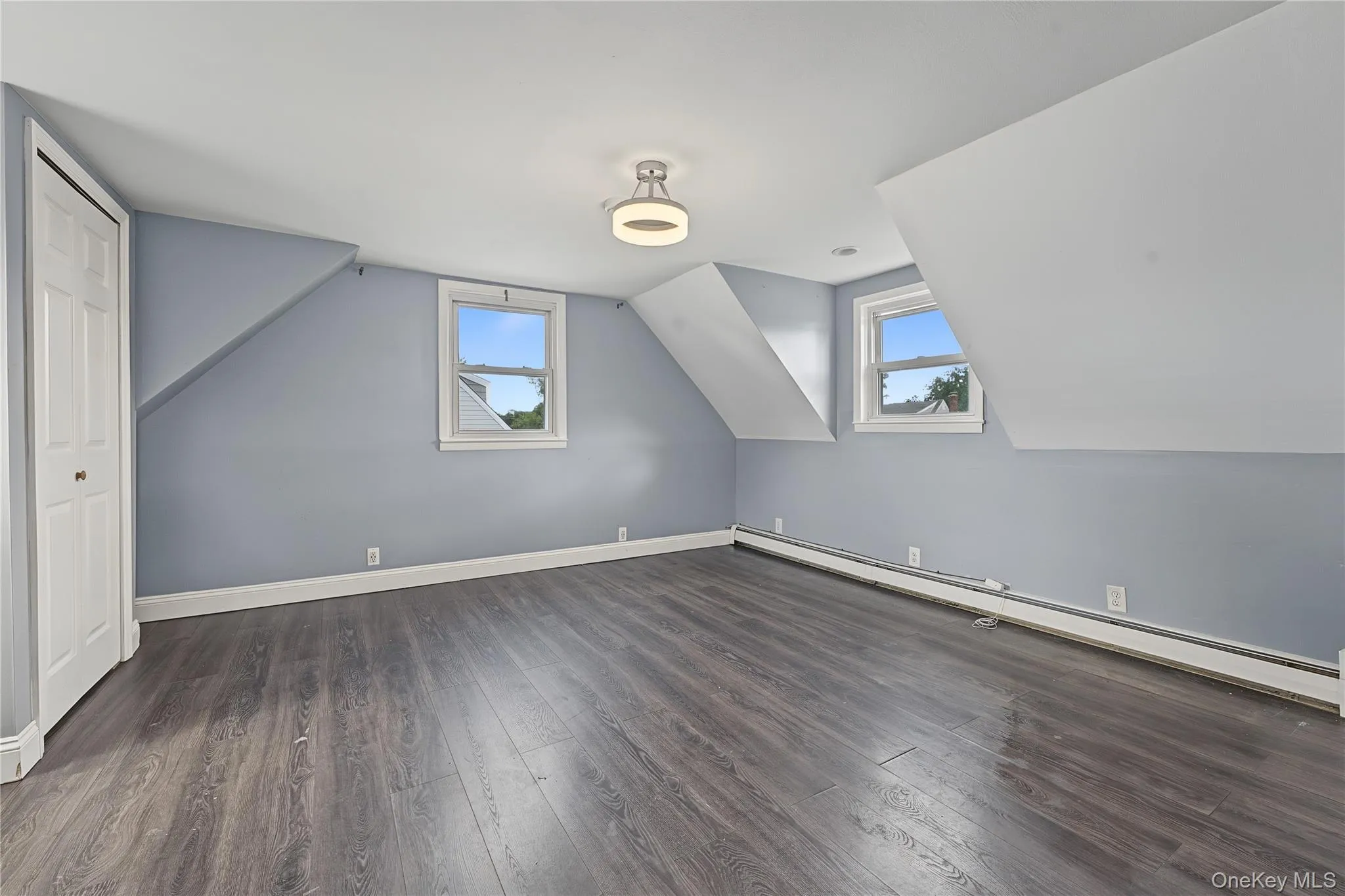 Third bedroom located on the second floor features a Sloped ceilings, two sash windows, bi-fold closet, and ceiling-mounted lighting fixture Third bedroom located on the second floor features a Sloped ceilings, two sash windows, bi-fold closet, and ceiling-mounted lighting fixture