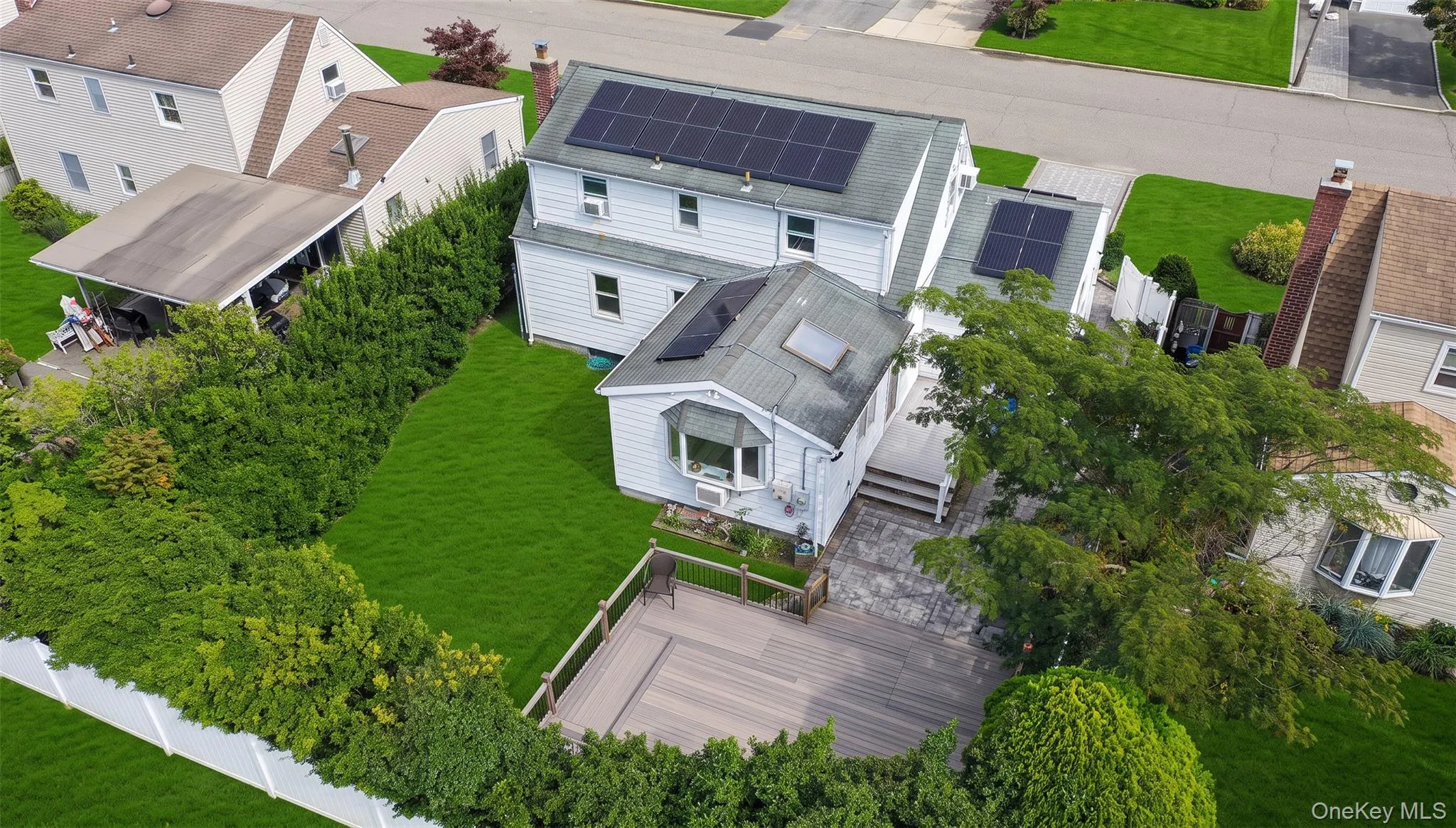 Expansive backyard with a composite deck, and mature privacy landscaping Expansive backyard with a composite deck, and mature privacy landscaping