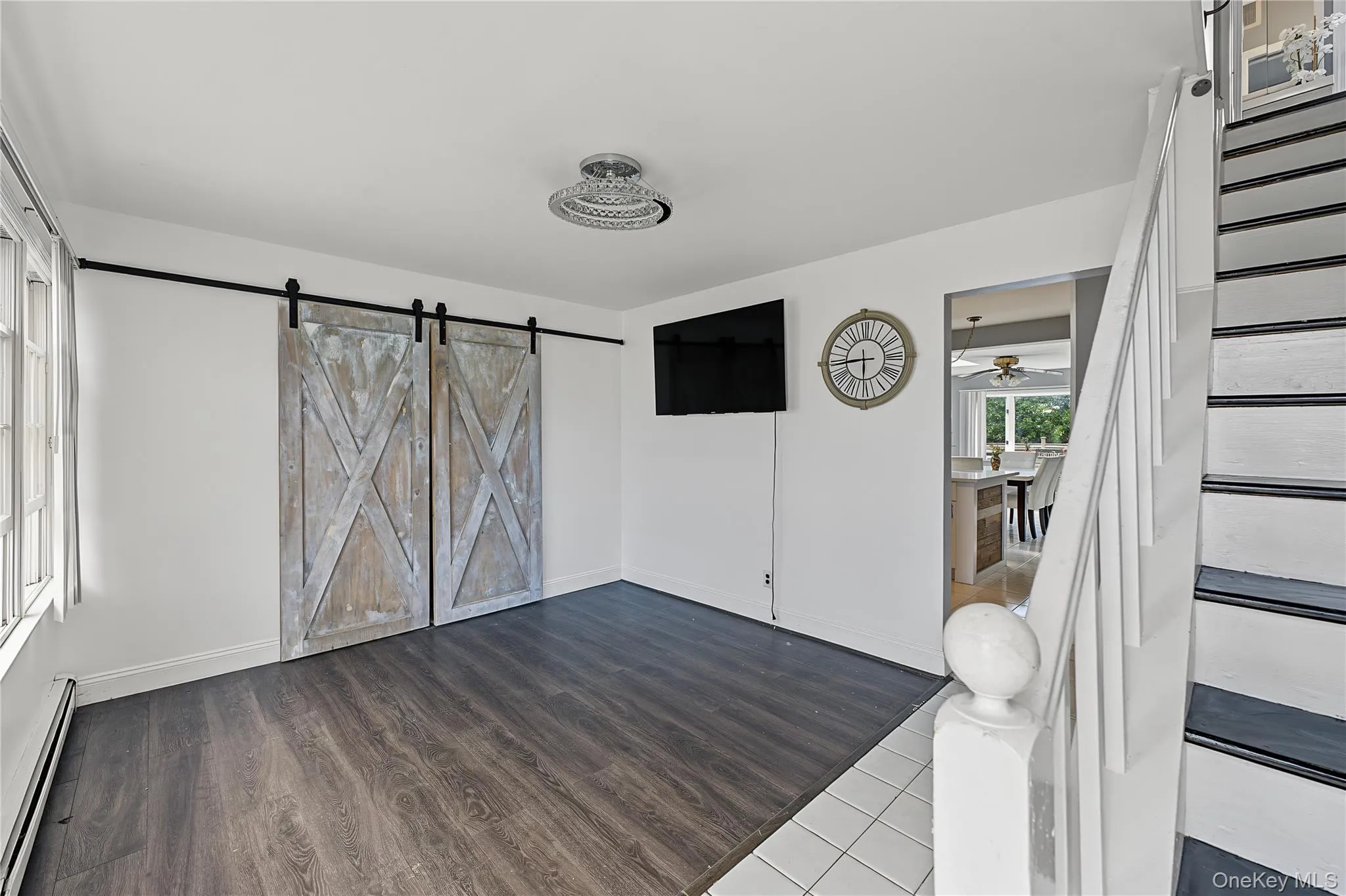 view from the front door features vinyl flooring, stylish barn doors that hide a large closet perfect for a workspace easily hidden or bar view from the front door features vinyl flooring, stylish barn doors that hide a large closet perfect for a workspace easily hidden or bar