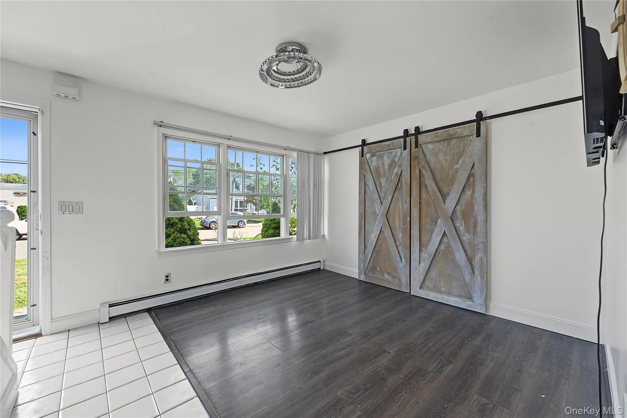 vinyl flooring with white baseboards view from the kitchen featuring the same barn doors vinyl flooring with white baseboards view from the kitchen featuring the same barn doors
