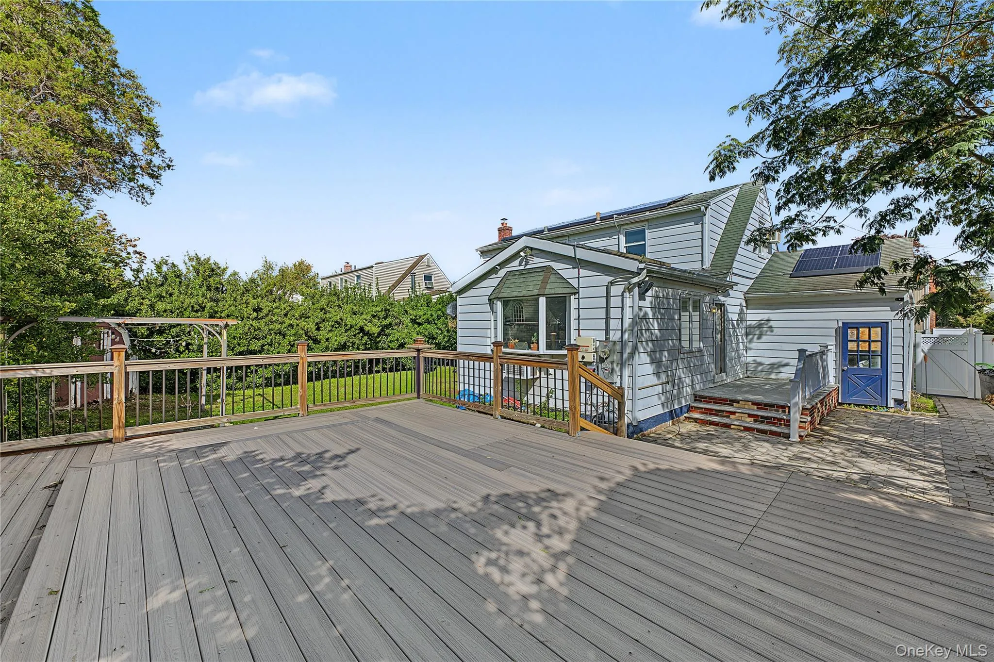Expansive outdoor deck with wood railing Expansive outdoor deck with wood railing