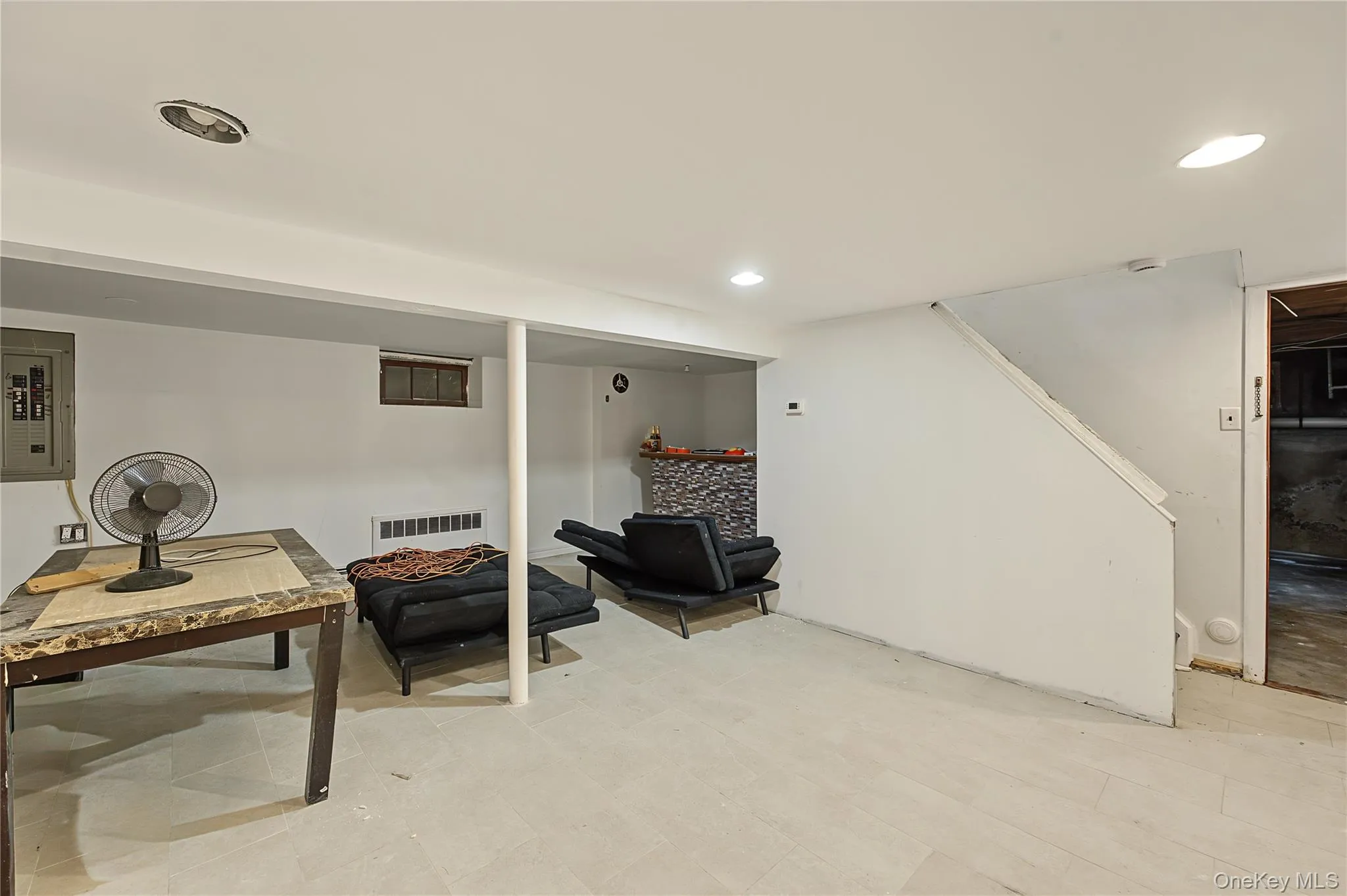Finished lower level space featuring recessed lighting, holds endless possibilities with its tile flooring Finished lower level space featuring recessed lighting, holds endless possibilities with its tile flooring