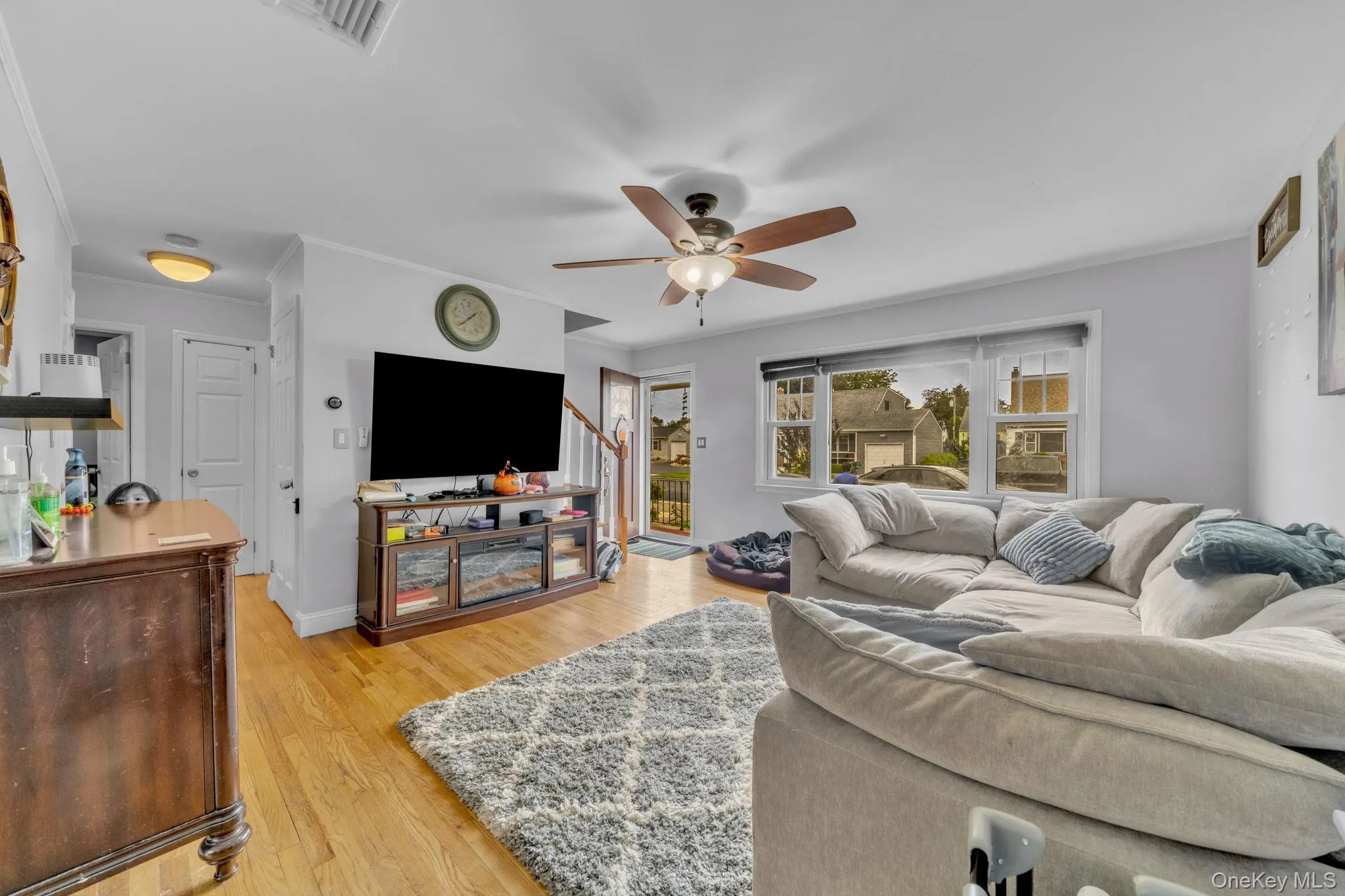 Hardwood flooring, recessed lighting, ceiling fan with integrated lighting, and multiple windows Hardwood flooring, recessed lighting, ceiling fan with integrated lighting, and multiple windows