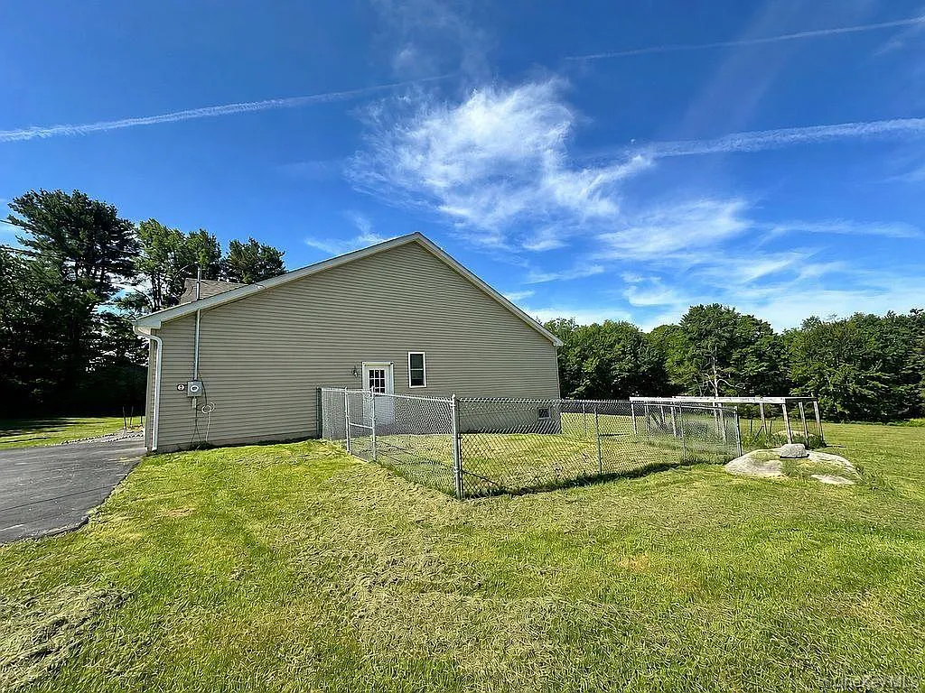Side of structure with fenced in area for dogs or garden Side of structure with fenced in area for dogs or garden
