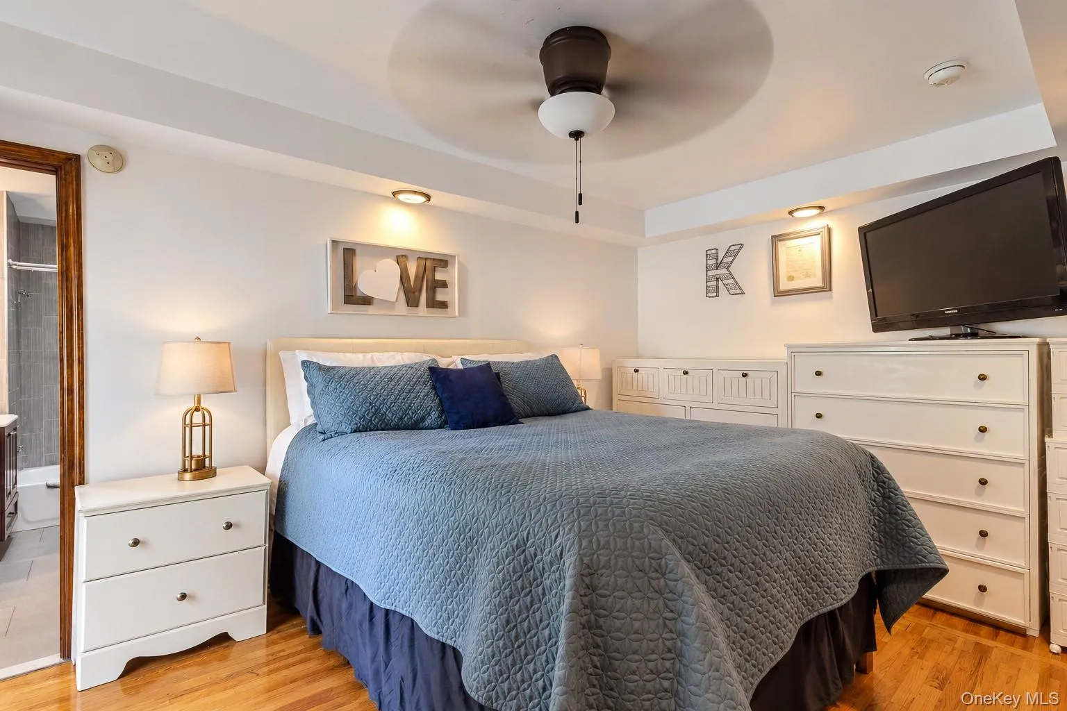 Bedroom featuring hardwood flooring, recessed ceiling lighting, a central ceiling fan, and crown molding Bedroom featuring hardwood flooring, recessed ceiling lighting, a central ceiling fan, and crown molding