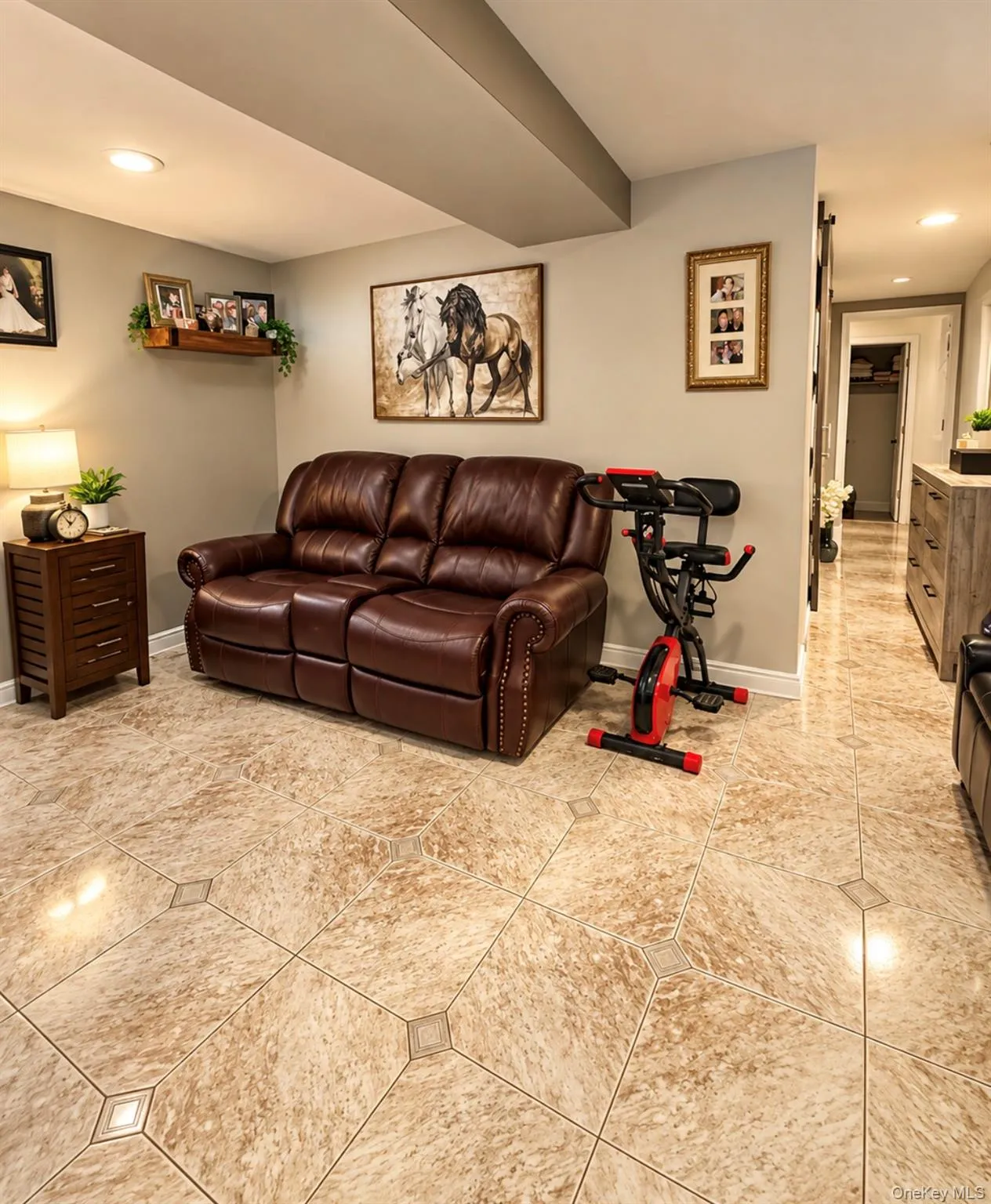 Recessed lighting, wood-finish wall shelving, and tile flooring with accent inserts Recessed lighting, wood-finish wall shelving, and tile flooring with accent inserts