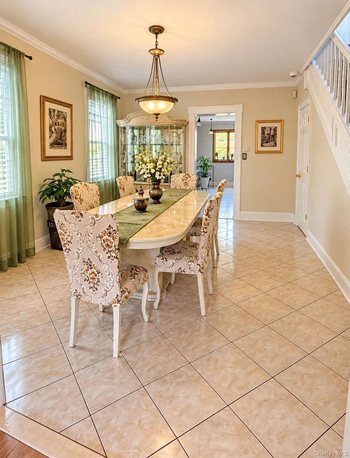 Tile flooring with contrasting border, crown molding, and a chandelier lighting fixture Tile flooring with contrasting border, crown molding, and a chandelier lighting fixture