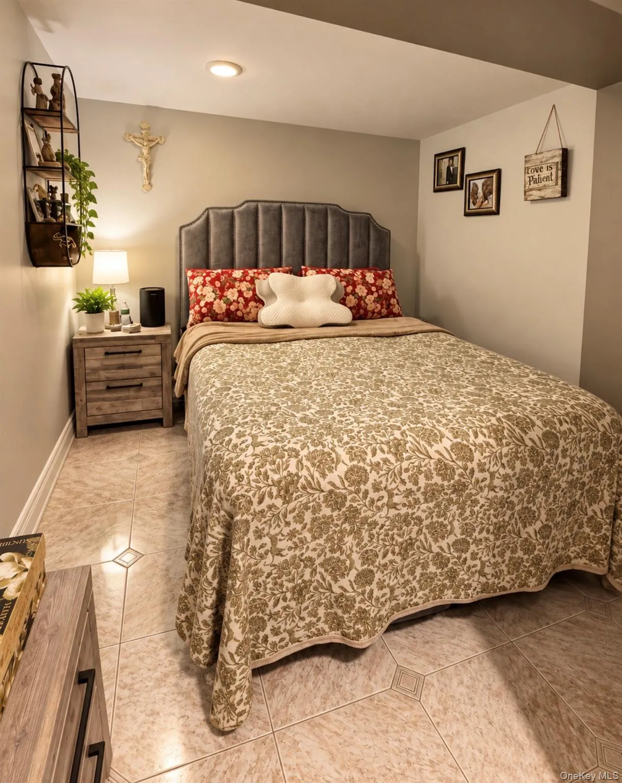 Recessed lighting, tiled flooring, upholstered headboard, and wood-finish nightstands Recessed lighting, tiled flooring, upholstered headboard, and wood-finish nightstands